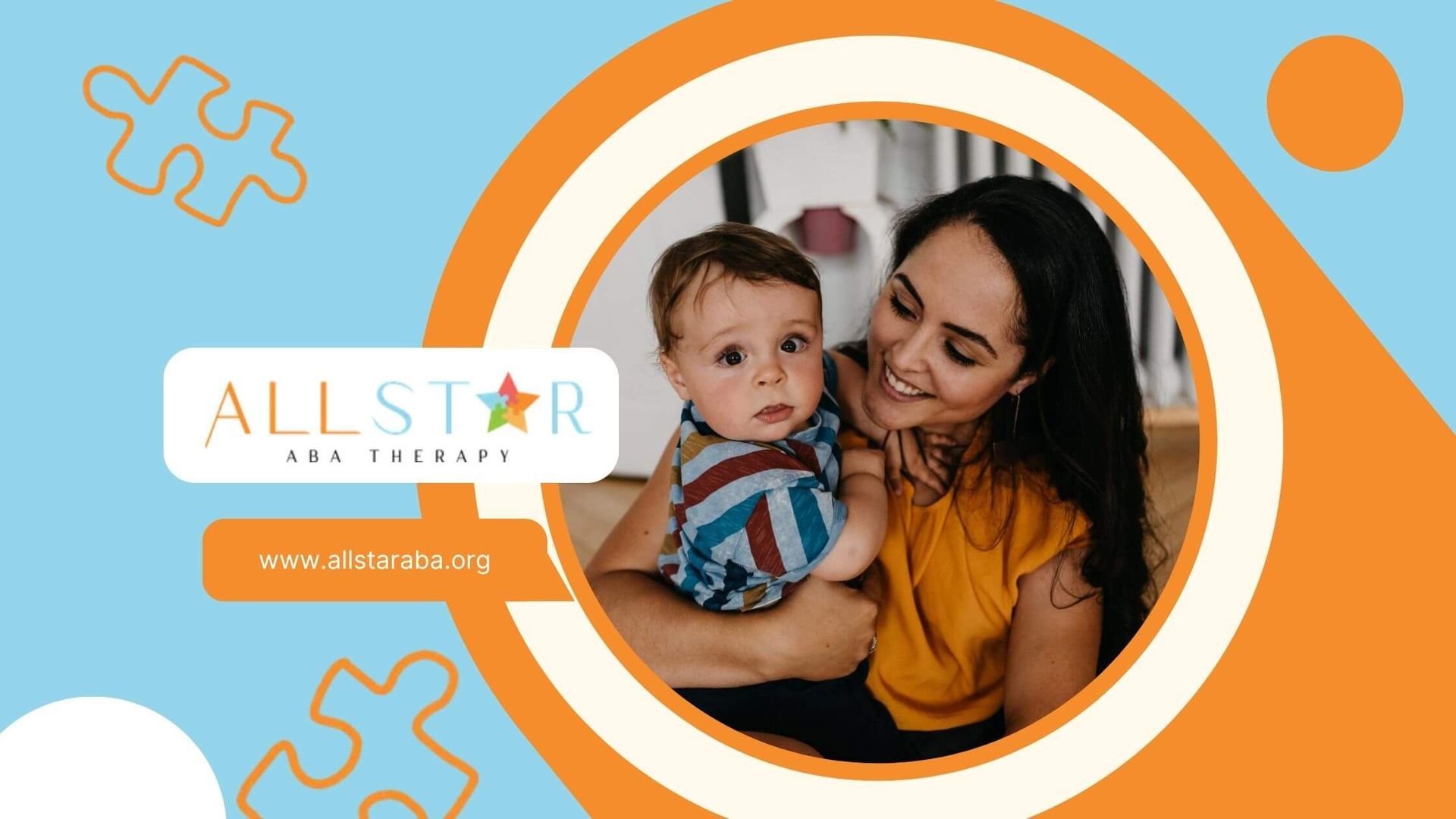 A child with autism looks at the camera while an ABA therapist holds him.