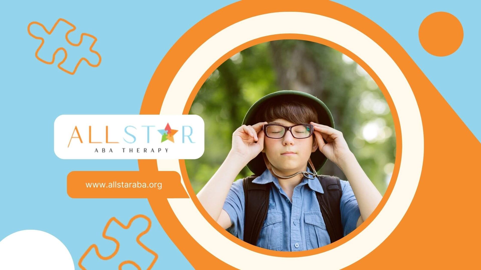 A young autistic boy wearing glasses and a green hat, squinting his eyes while enjoying nature.