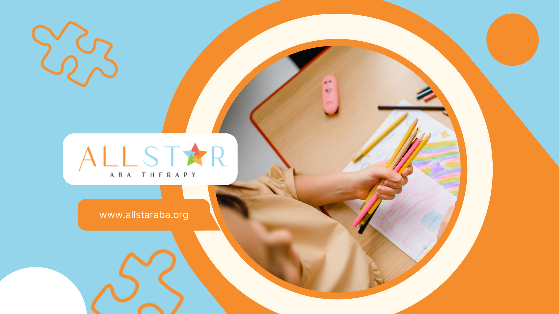 A child is sitting at a desk holding colored pencils.