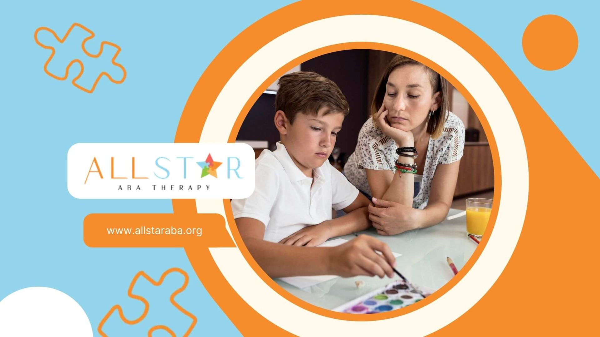 Female ABA therapist looking over to autistic boys' shoulder as he paints on a piece of paper.