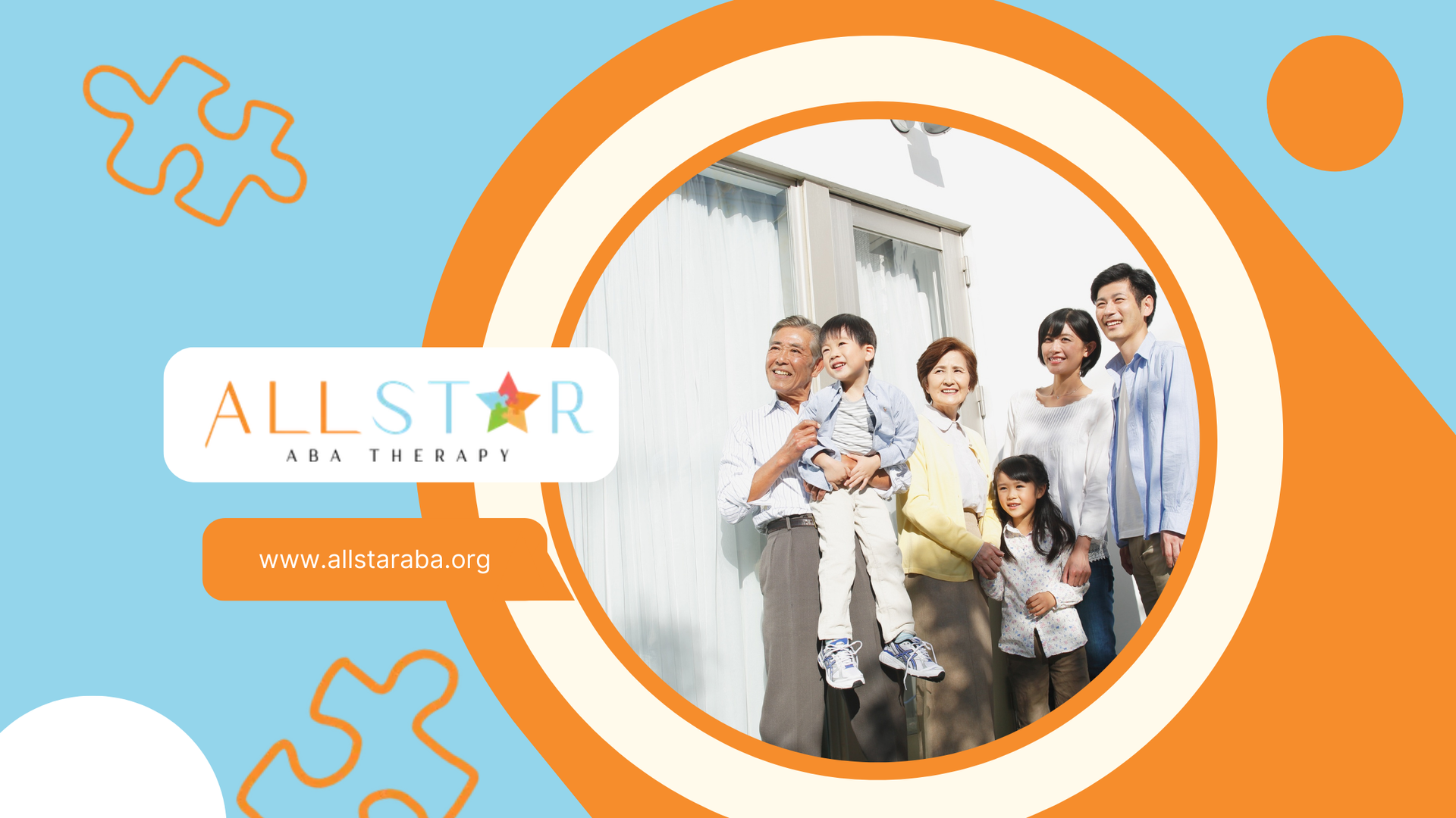 A multi-generational Asian family smiles together outdoors in front of a sunny wall.