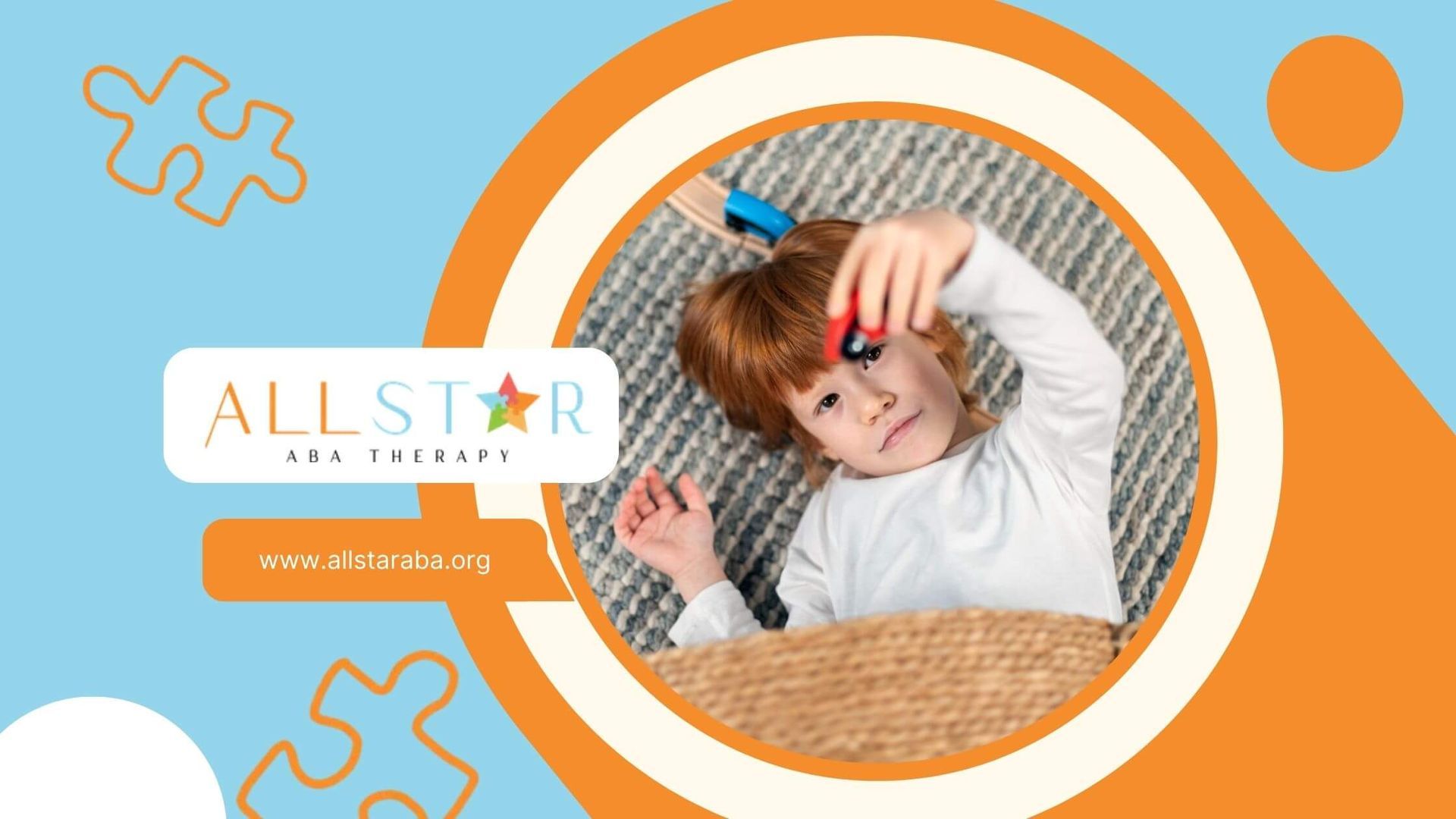 Autistic child lying on the floor playing with a toy car and wooden train tracks during ABA therapy.