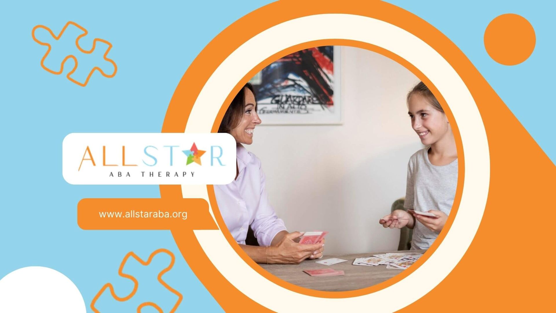 A female ABA therapist and a girl smiling while playing cards at a table in a cozy living room.