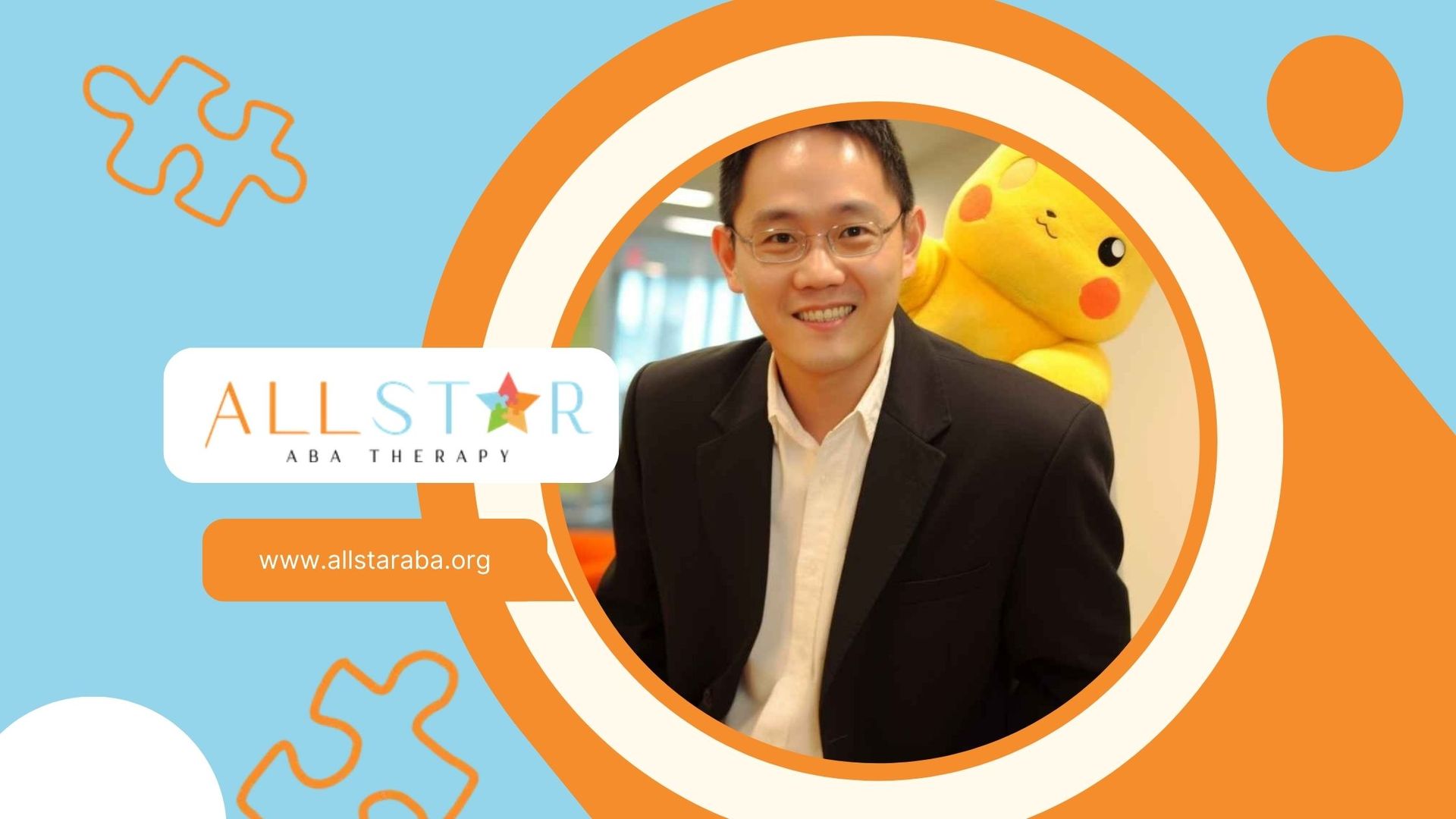 Satoshi Tajiri smiling with a plush Pikachu resting on his shoulder in his office space in Maryland.