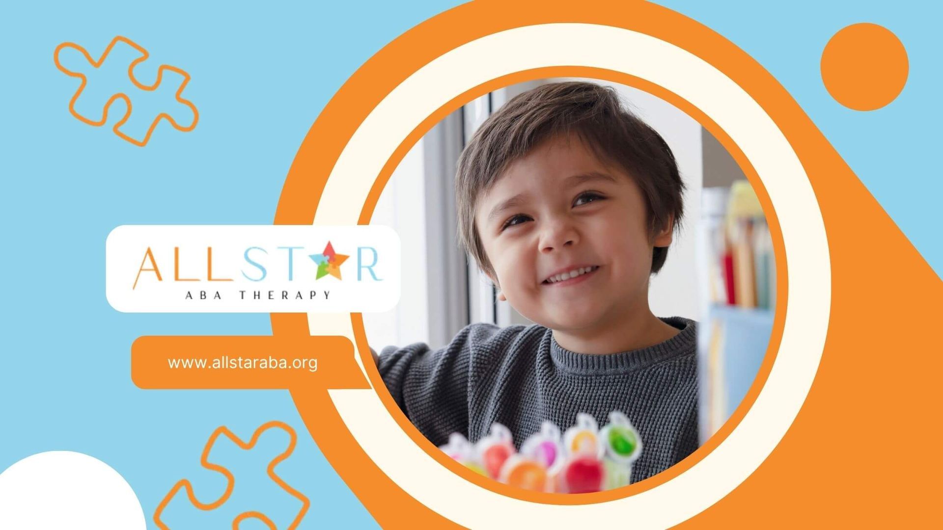 A young boy with autism is smiling and looking up at the camera.