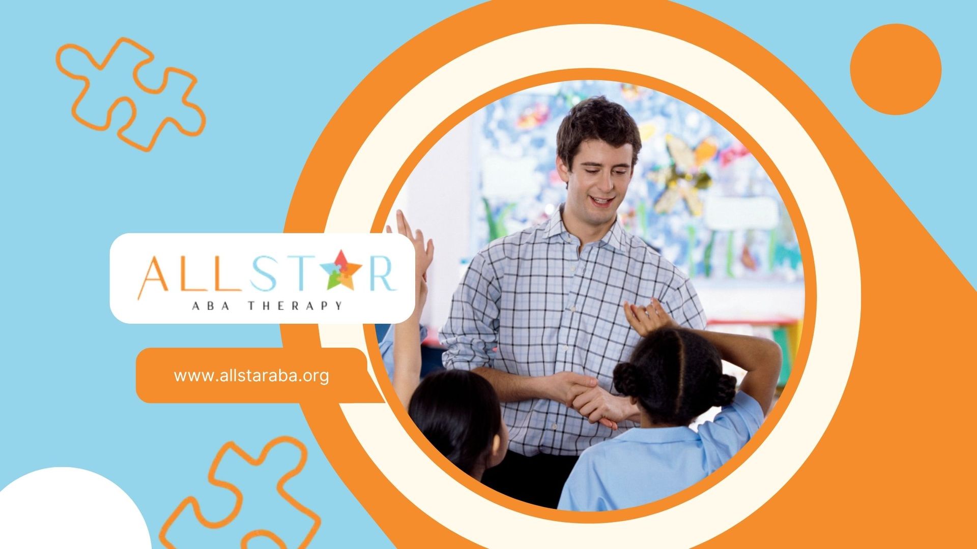 A smiling man interacts with children in a classroom. The logo 