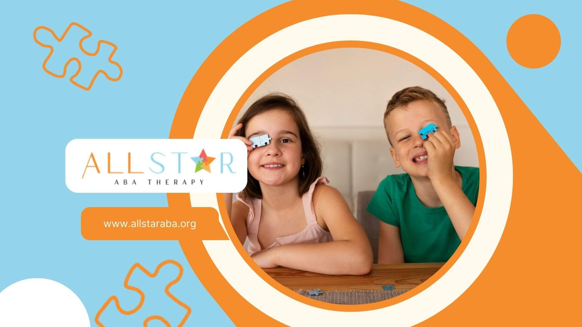 Two children with autism holding puzzle pieces and smiling at a table.