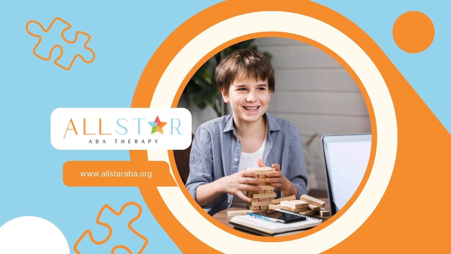 A boy smiling while stacking wooden blocks, playing a game in front of a laptop with a woman.