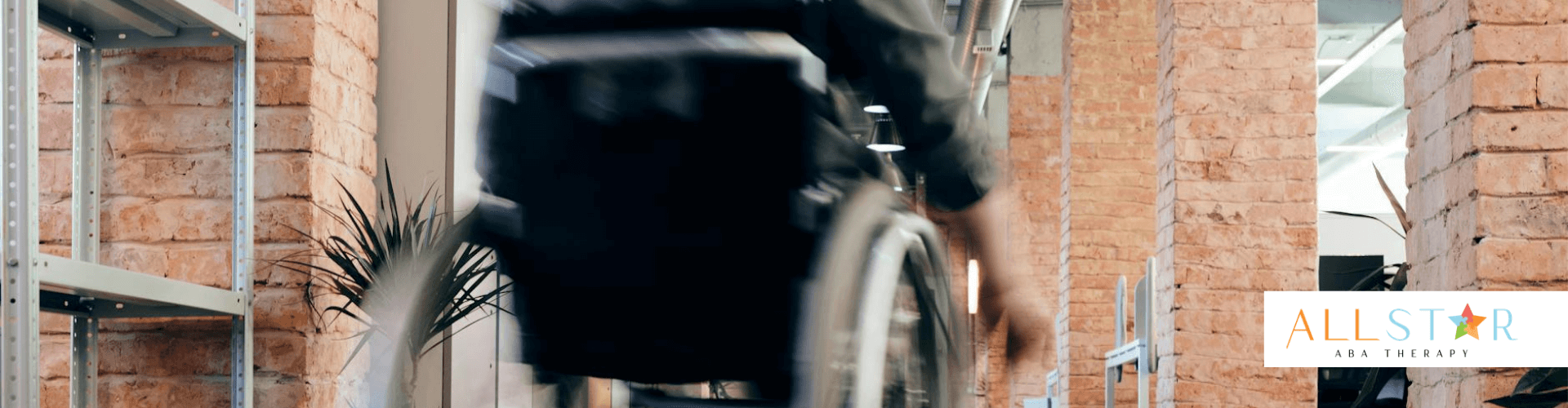 An autistic person rolling a wheelchair down a corridor to attend an ABA therapy in Maryland.