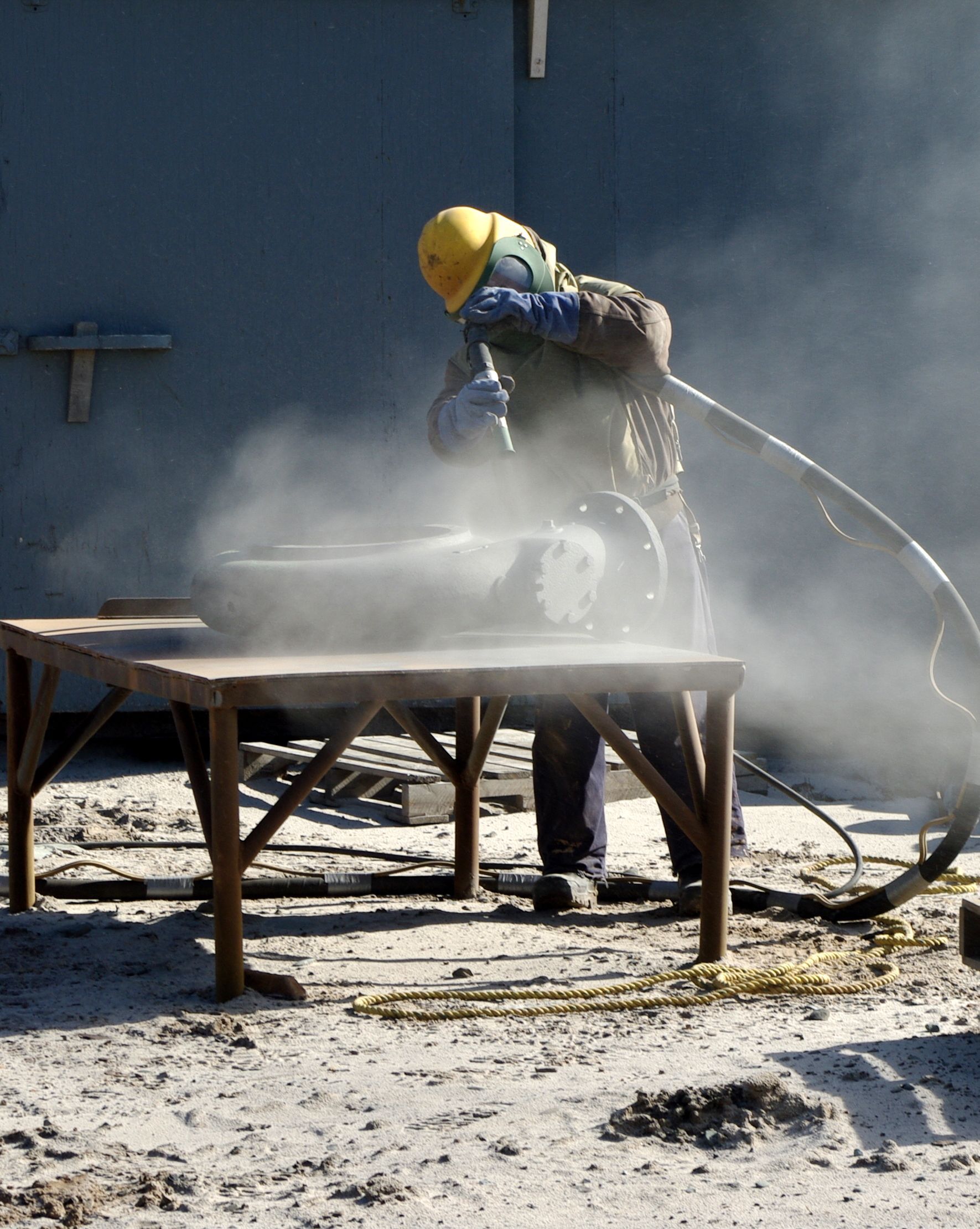 A man in a yellow helmet, emphasizing their range of Blasting Equipment 