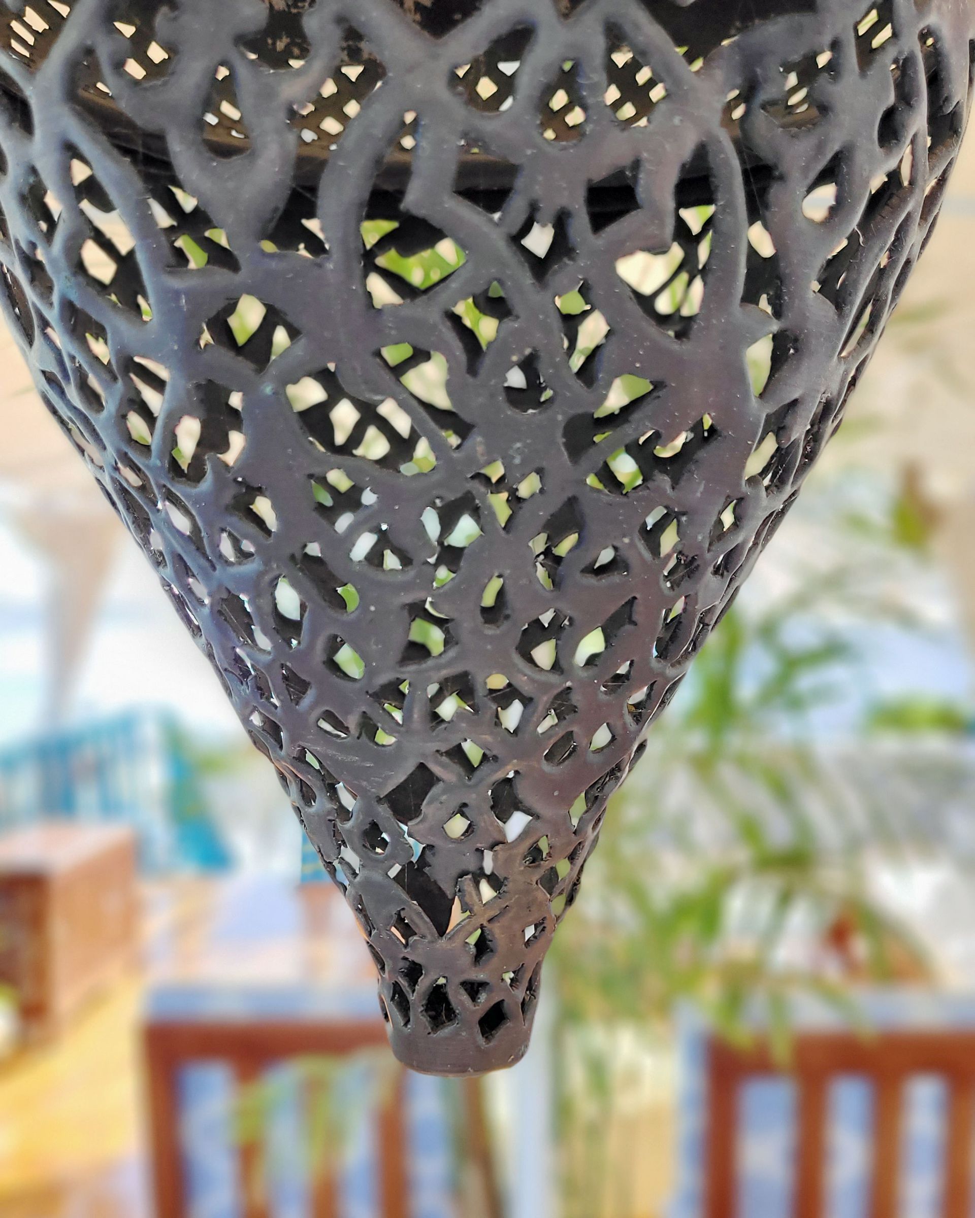An antique copper lamp on a historic boat sailing the Nile. The boat is the Dahabiya Kingfisher, which was built in 1899 and offers private cruises between Luxor and Aswan in Egypt.