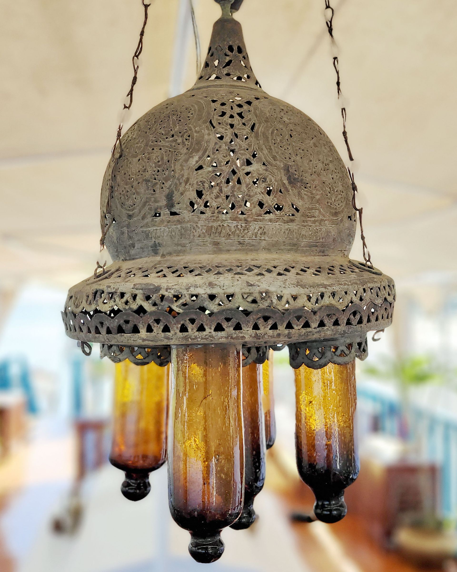 An antique copper lamp on a historic boat sailing the Nile. The boat is the Dahabiya Kingfisher, which was built in 1899 and offers private cruises between Luxor and Aswan in Egypt.