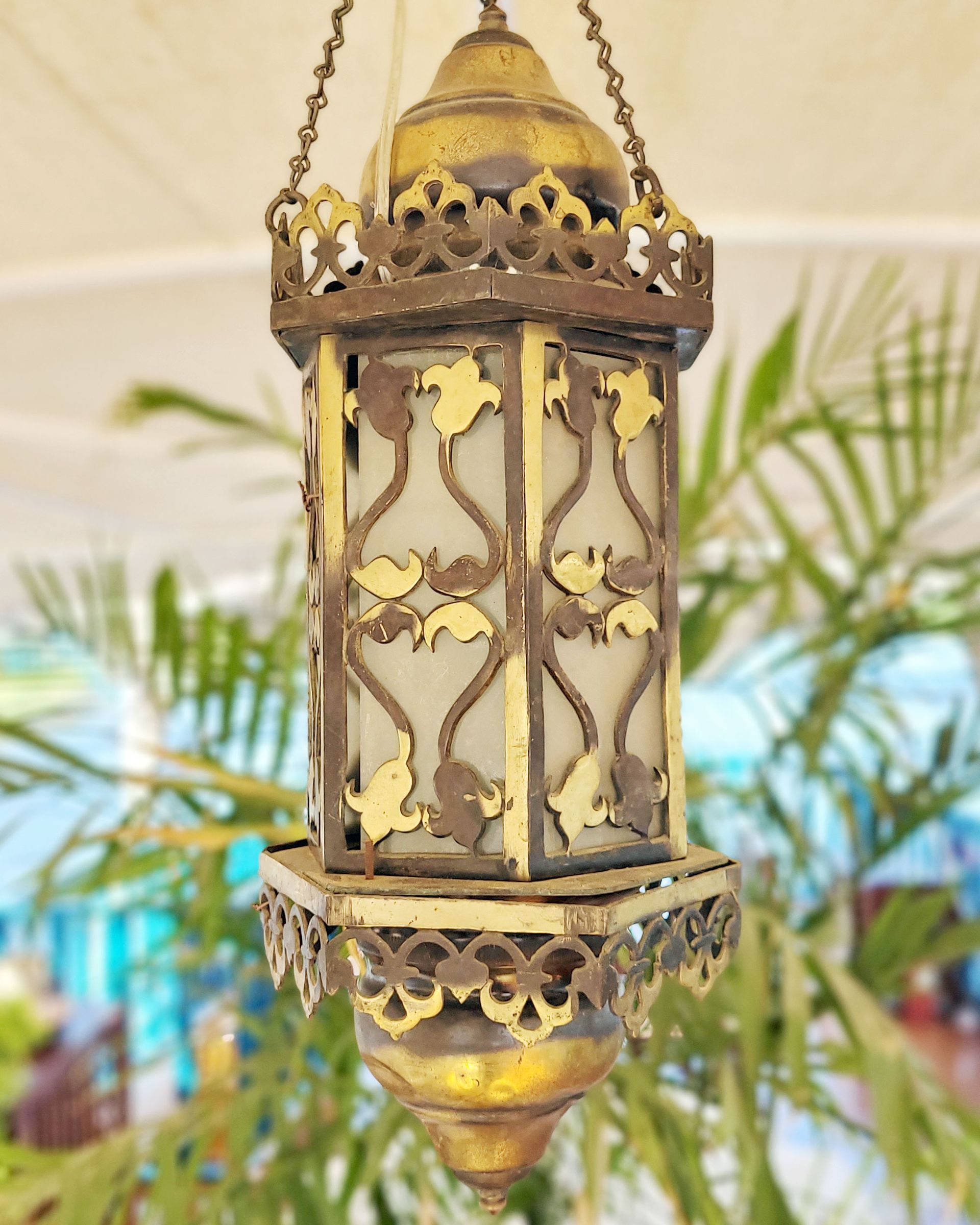 An antique copper lamp on a historic boat sailing the Nile. The boat is the Dahabiya Kingfisher, which was built in 1899 and offers private cruises between Luxor and Aswan in Egypt.