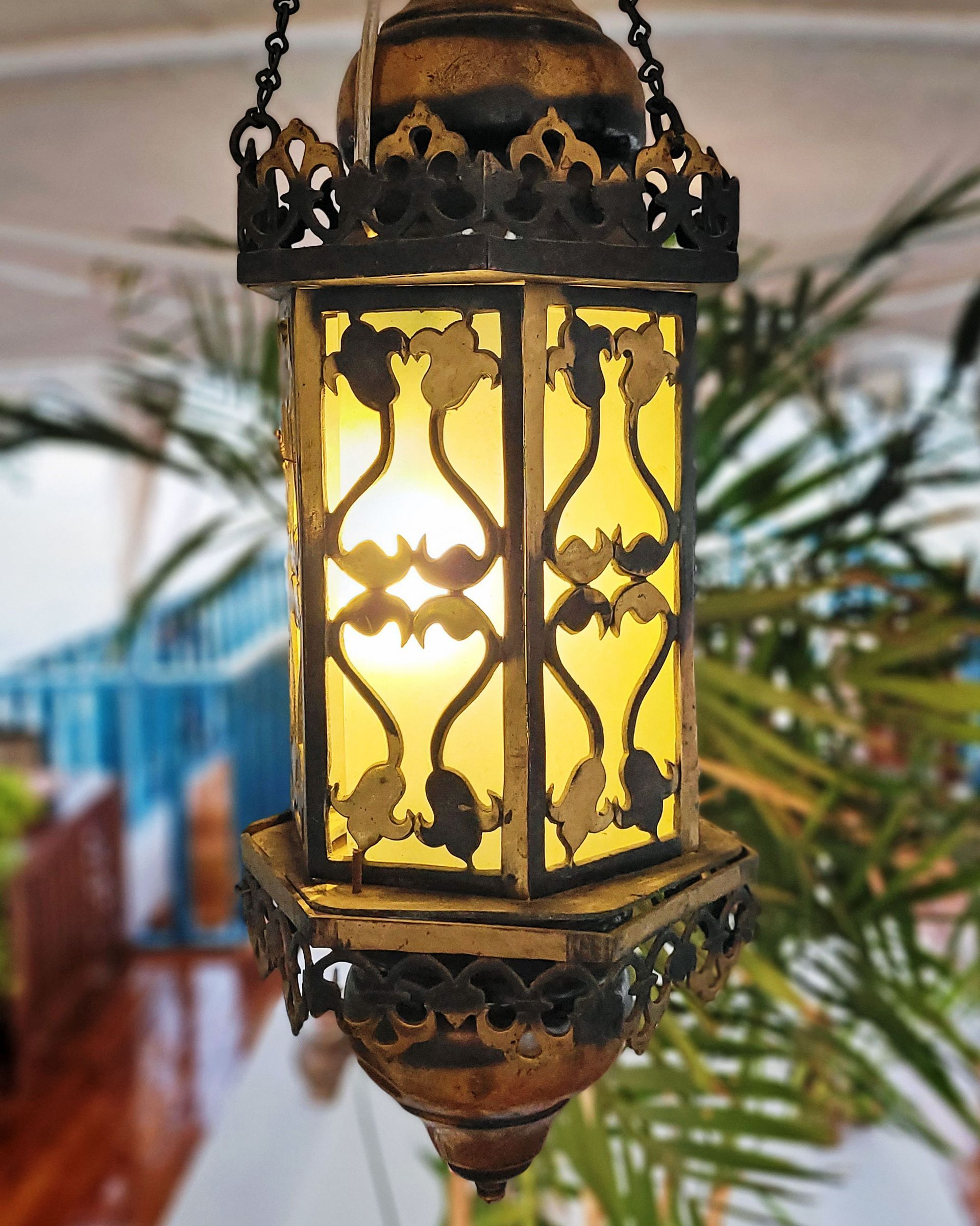 An antique copper lamp on a historic boat sailing the Nile. The boat is the Dahabiya Kingfisher, which was built in 1899 and offers private cruises between Luxor and Aswan in Egypt.