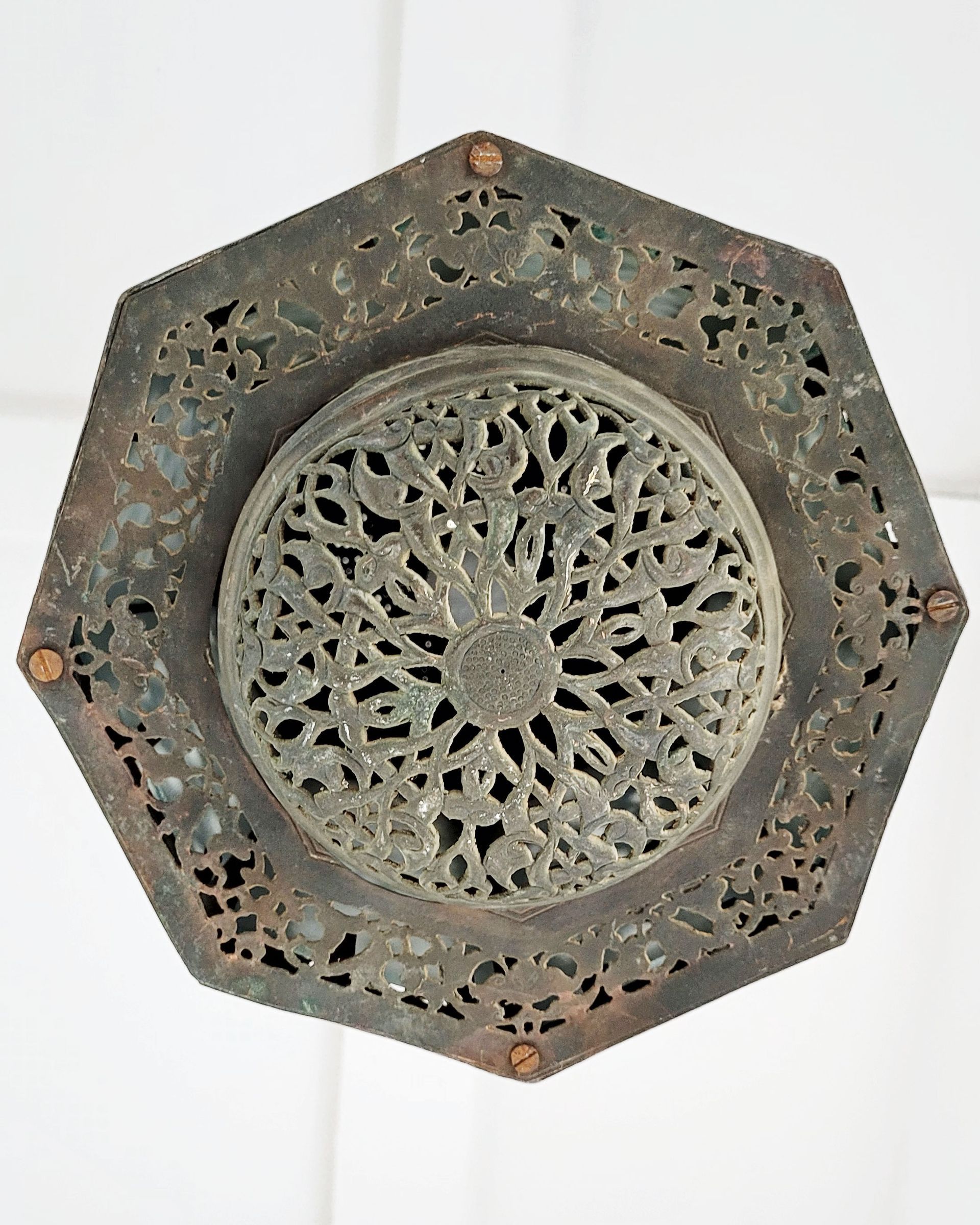 An antique copper lamp on a historic boat sailing the Nile. The boat is the Dahabiya Kingfisher, which was built in 1899 and offers private cruises between Luxor and Aswan in Egypt.