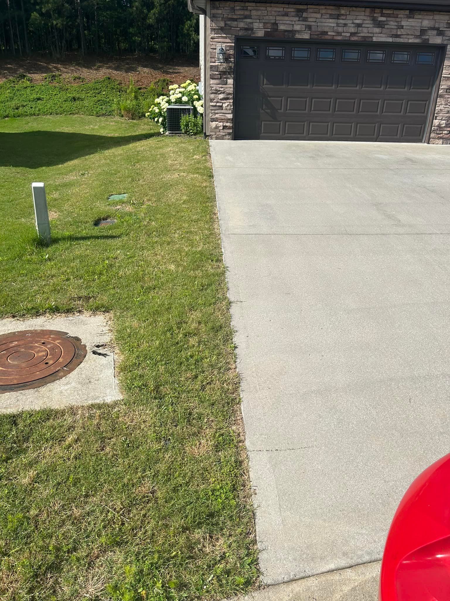 A red car is parked in front of a garage door.