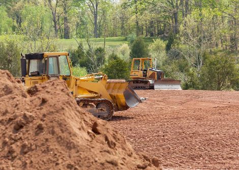 Two Bulldozers Working on a Dirt Field — Baton Rouge, LA — Capital City Tree Care LLC