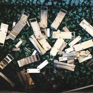 A bunch of metal pieces are laying on a green surface