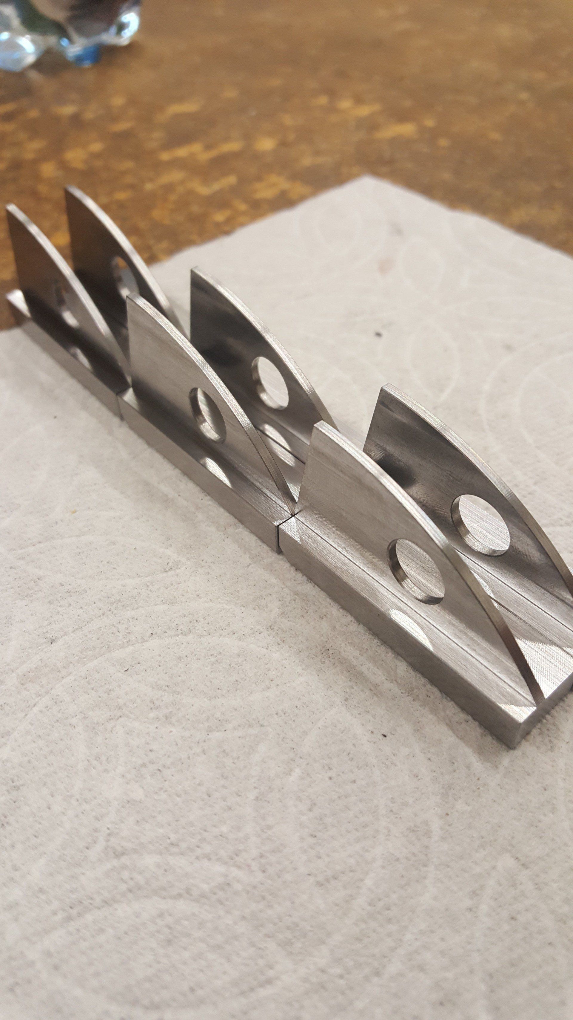 A piece of metal is sitting on top of a napkin on a table.