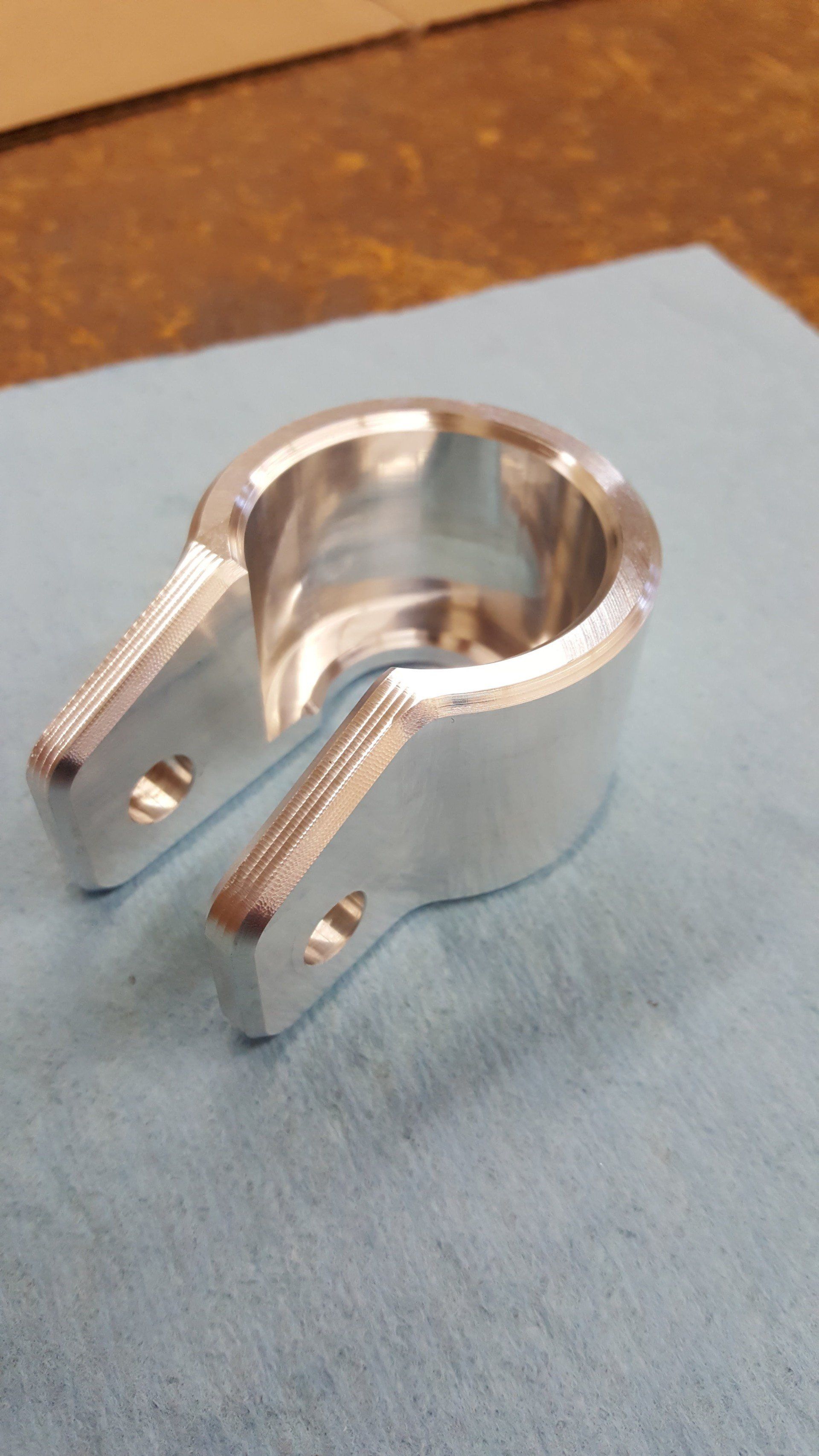 A metal object is sitting on top of a blue cloth on a table.