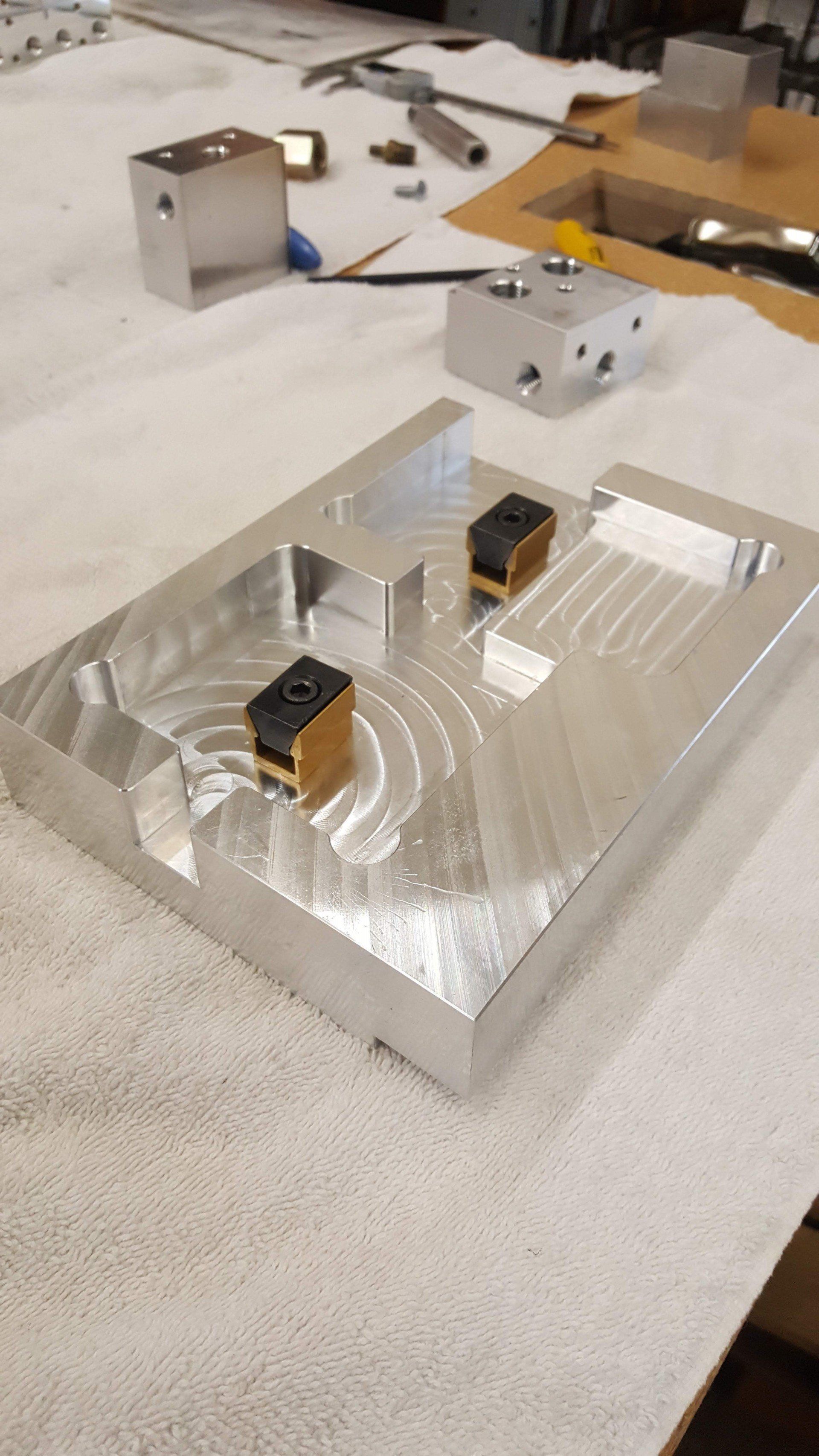 A piece of metal is sitting on top of a white towel on a table.