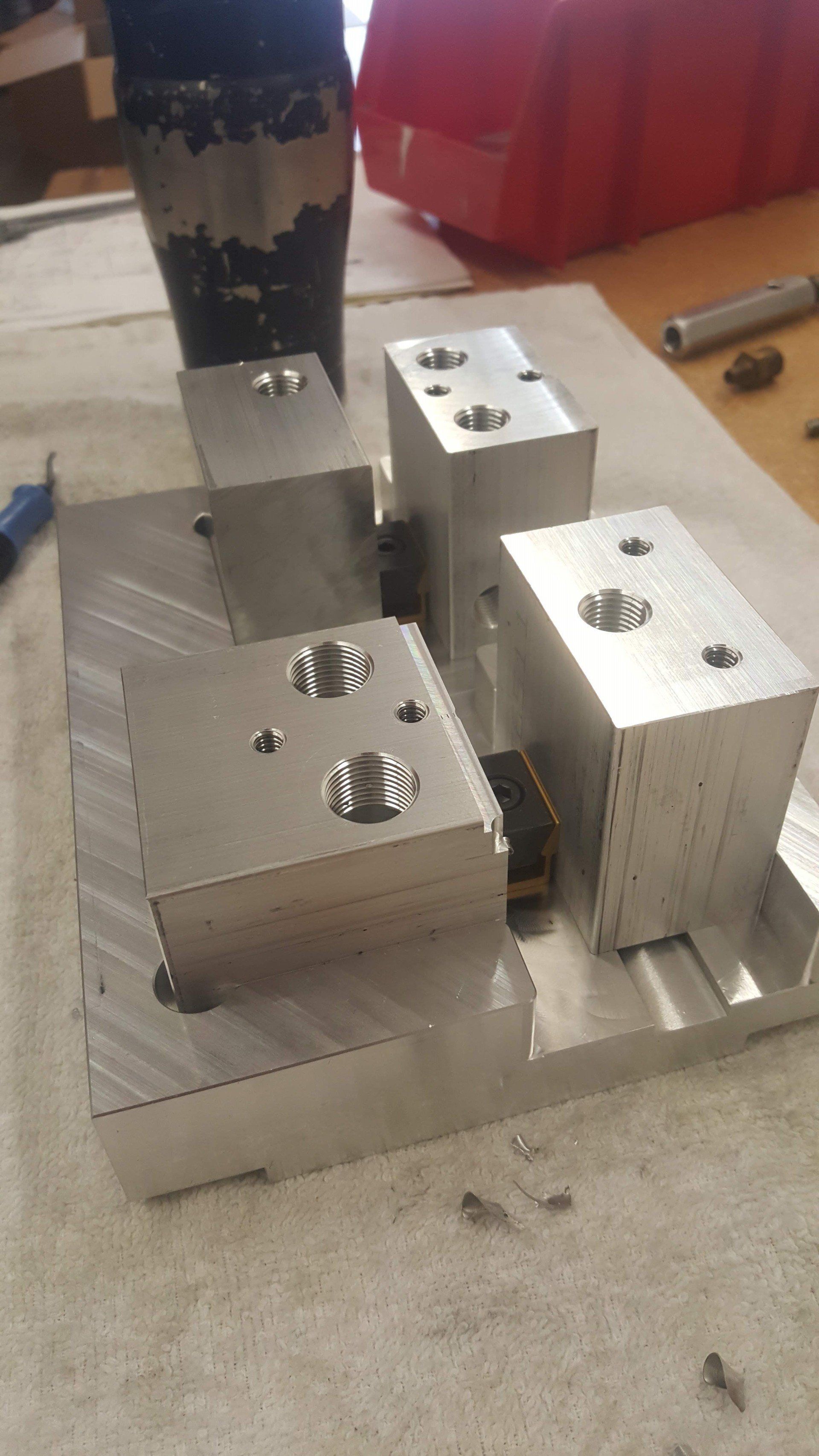 A bunch of metal blocks are sitting on top of each other on a table.