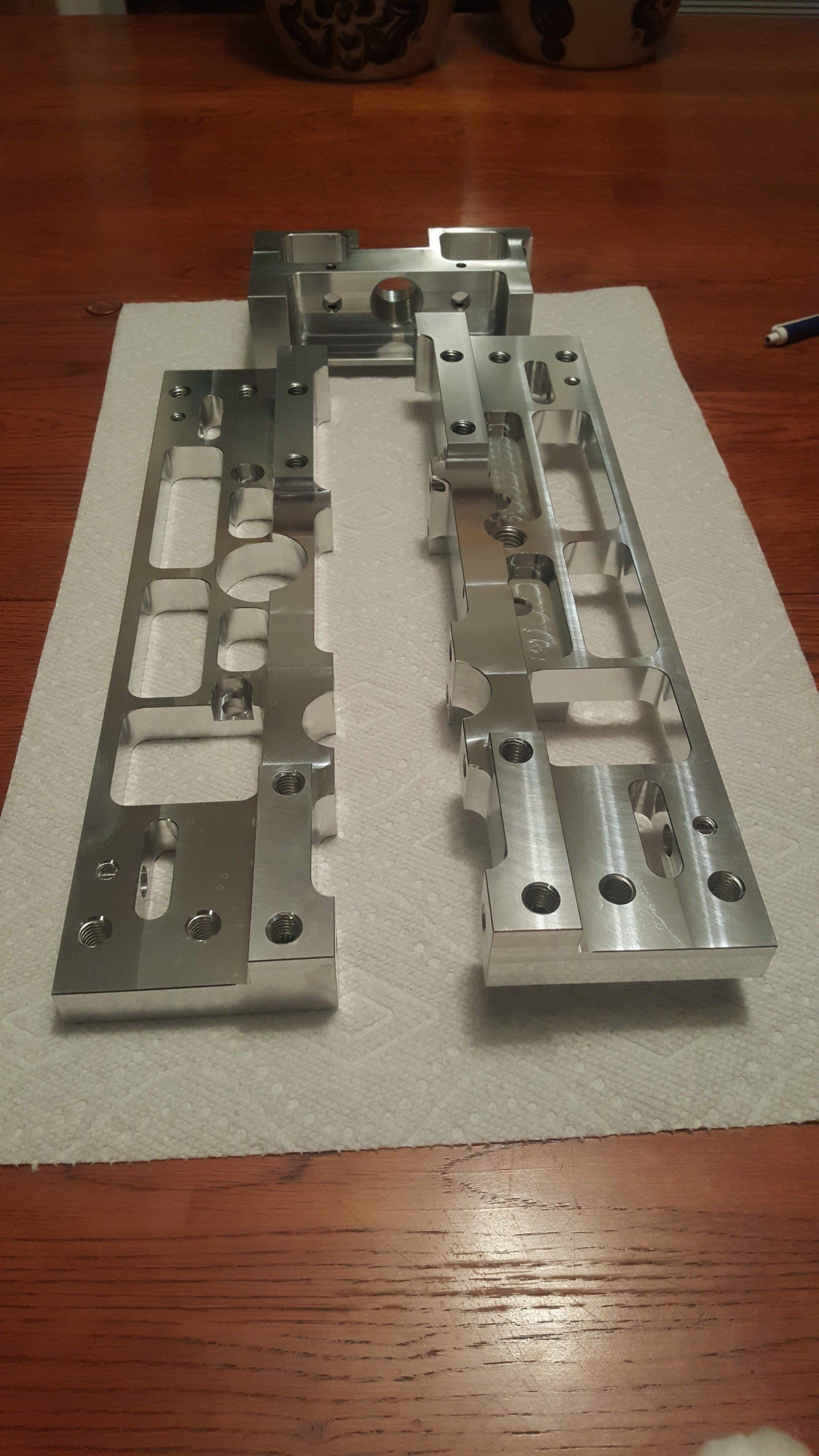 A piece of metal is sitting on a piece of paper on a wooden table.