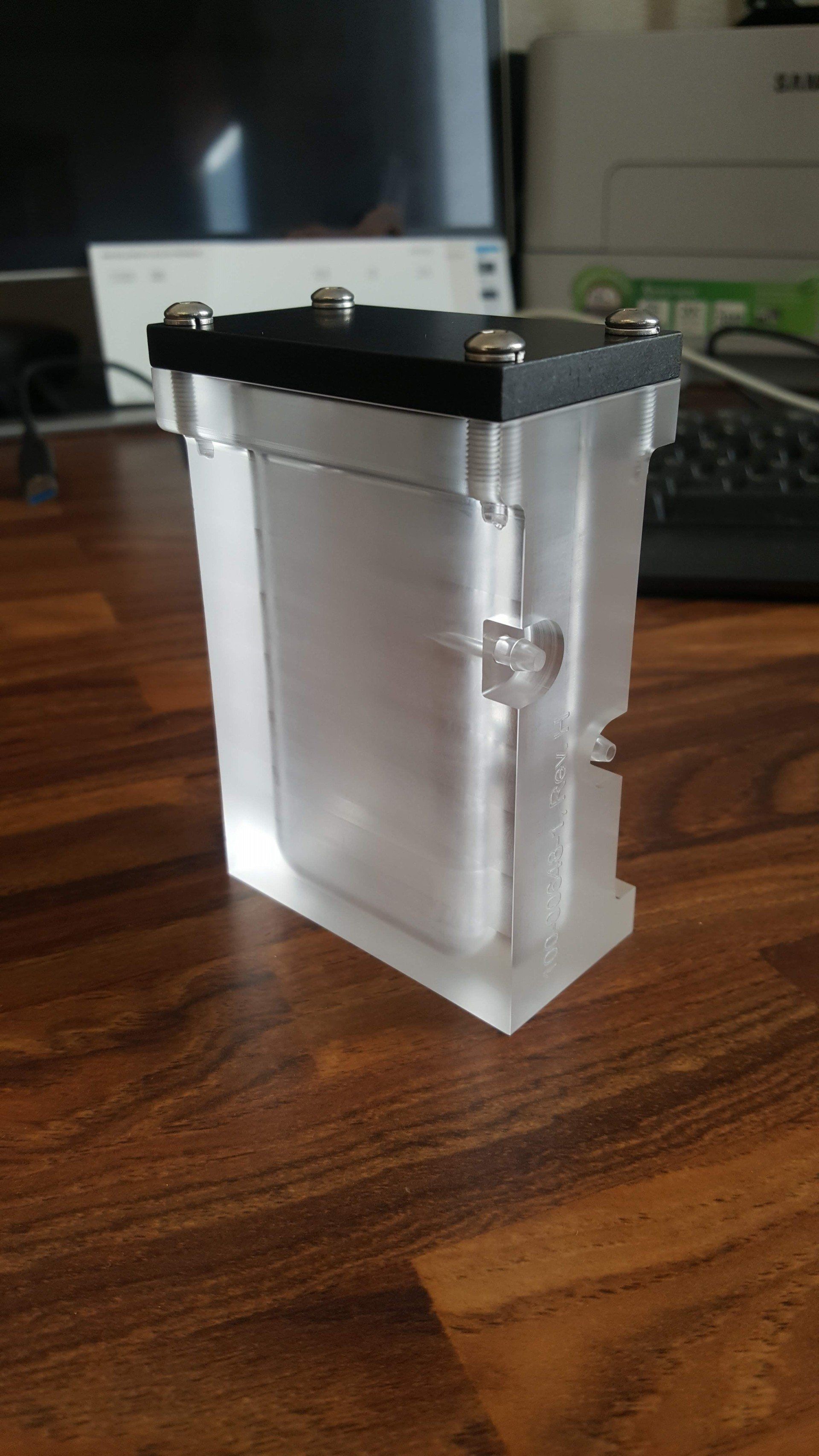 A small clear container is sitting on a wooden table.