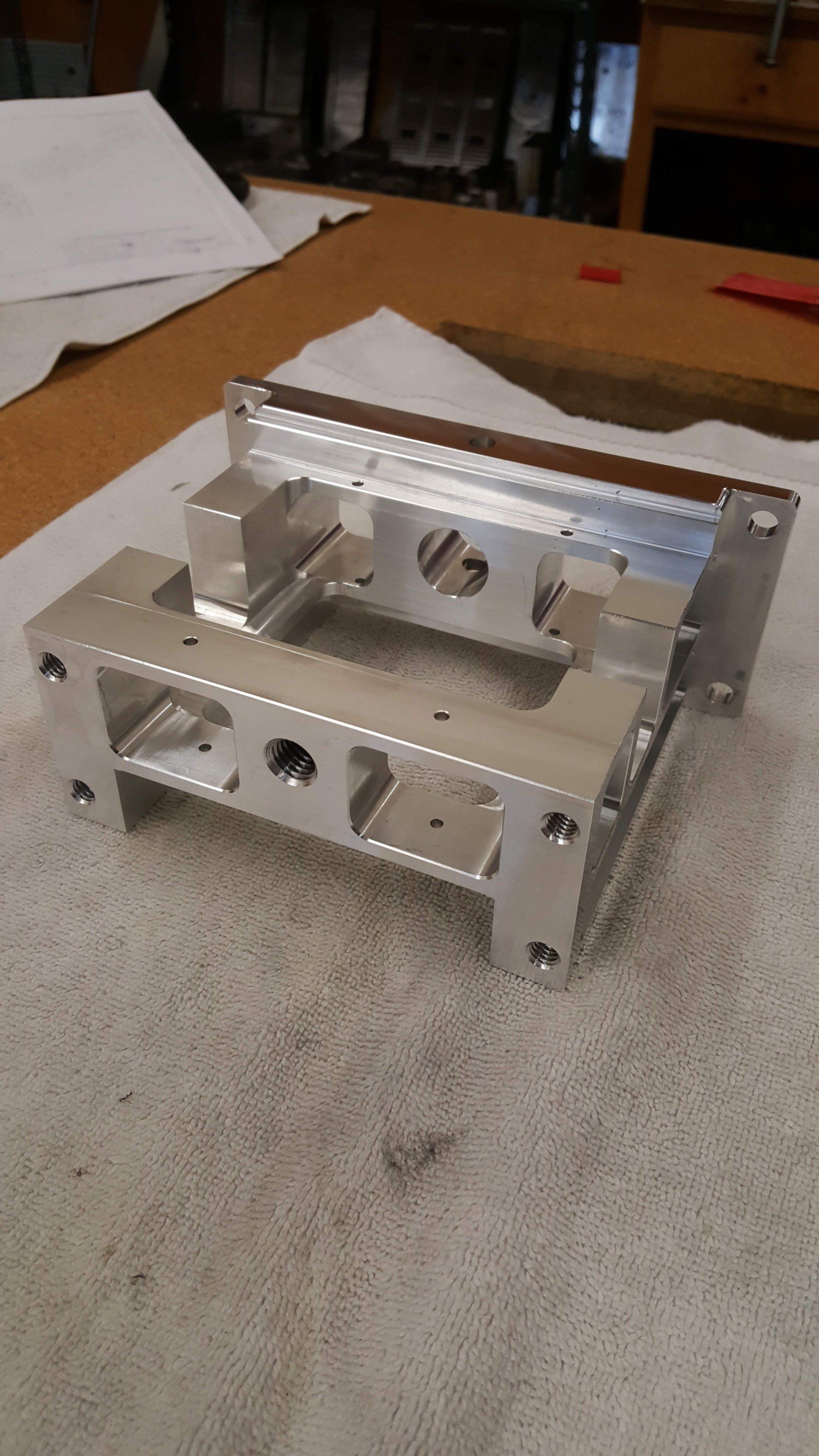 A piece of metal is sitting on top of a piece of paper on a table.