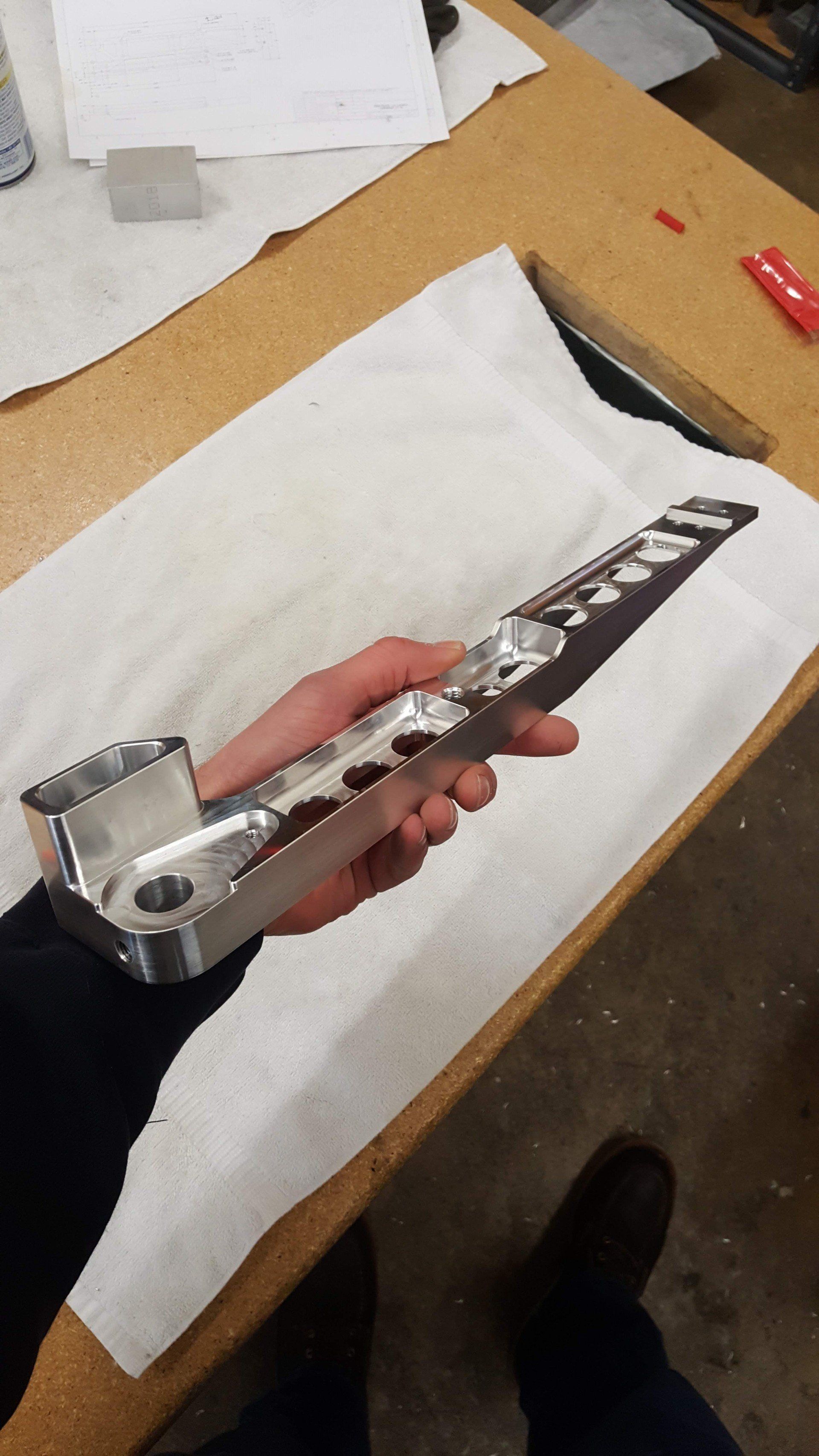 A person is holding a piece of metal in their hand.