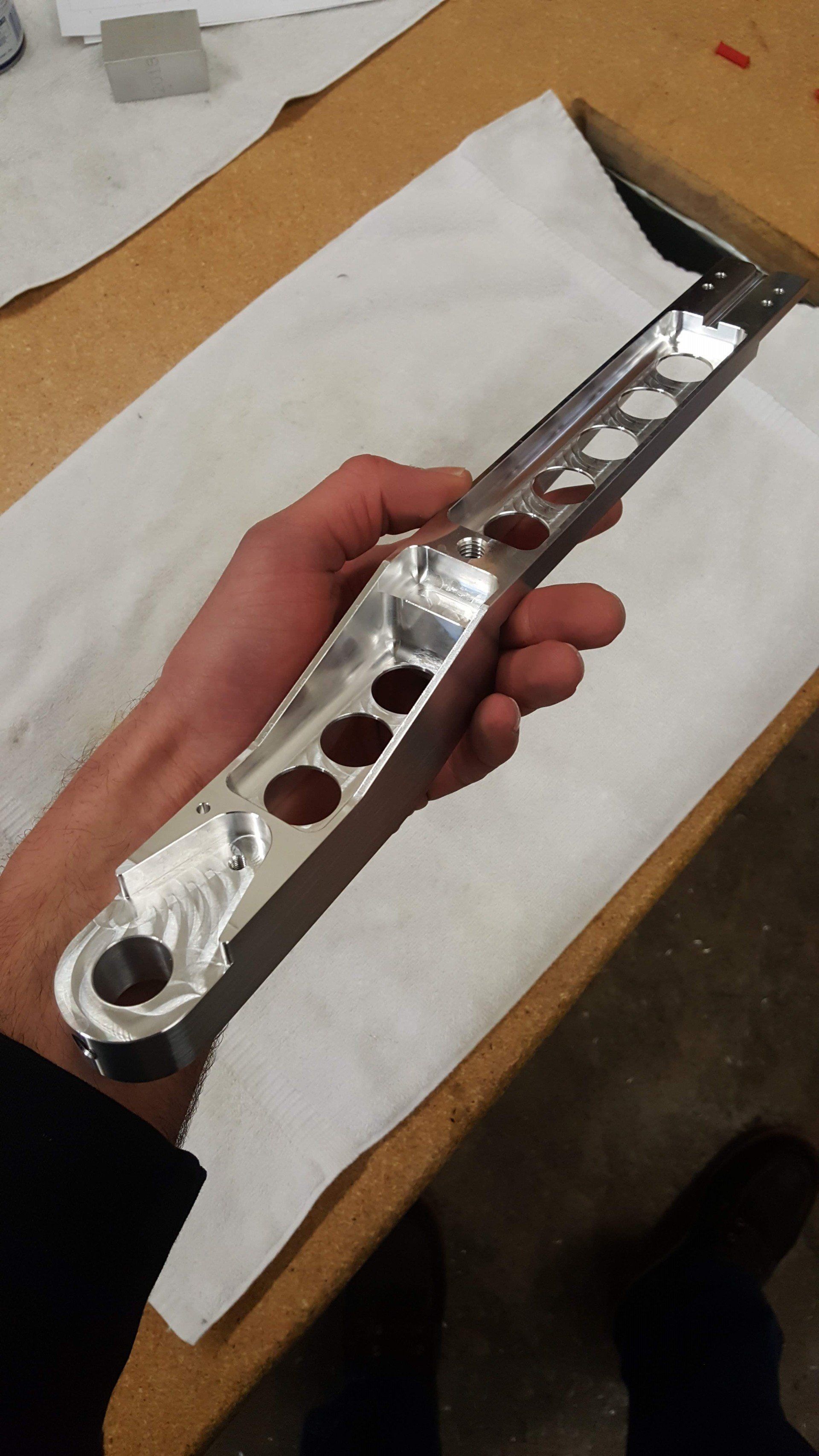 A person is holding a piece of metal in their hand.