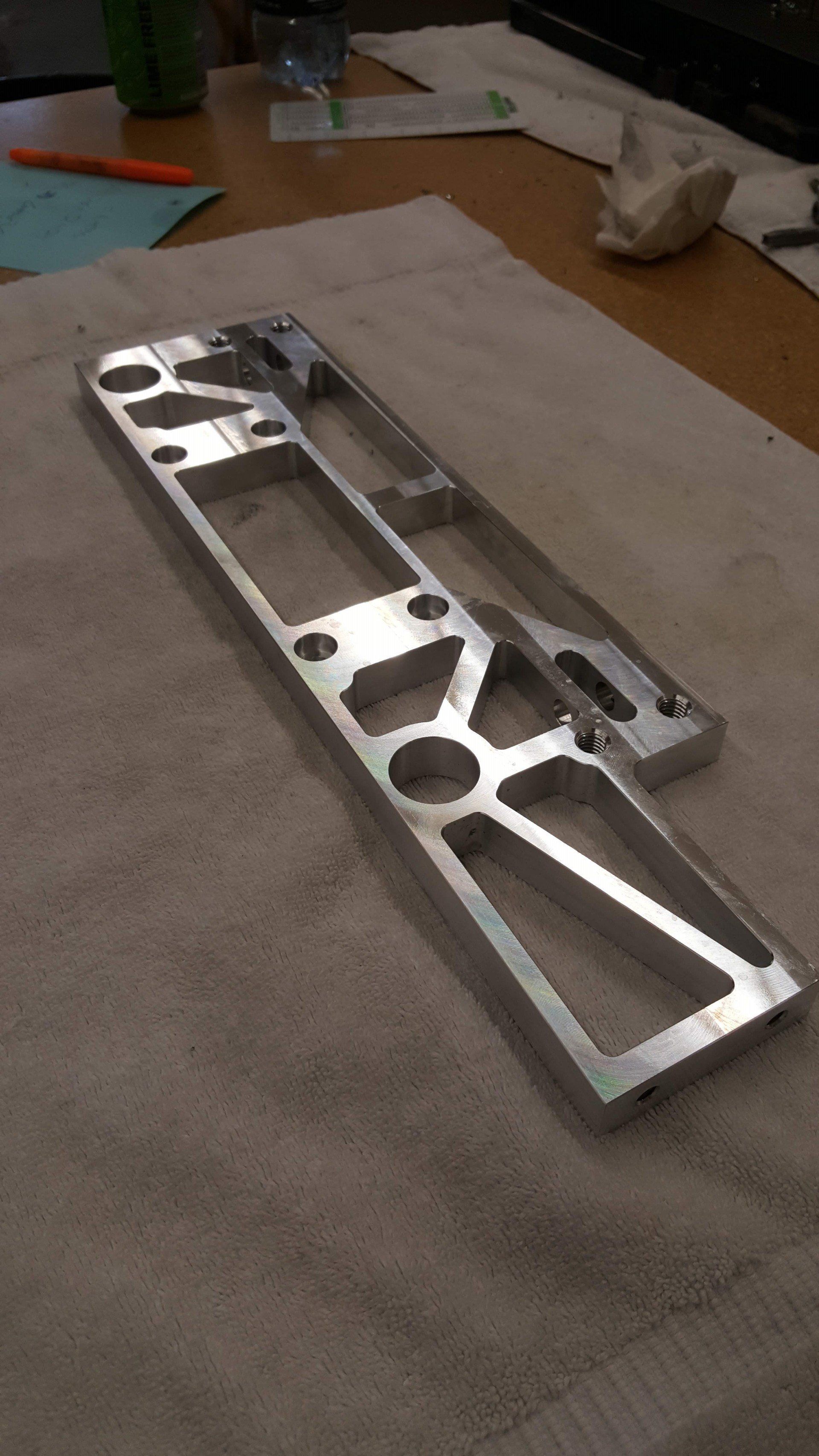 A piece of metal is sitting on a towel on a table.