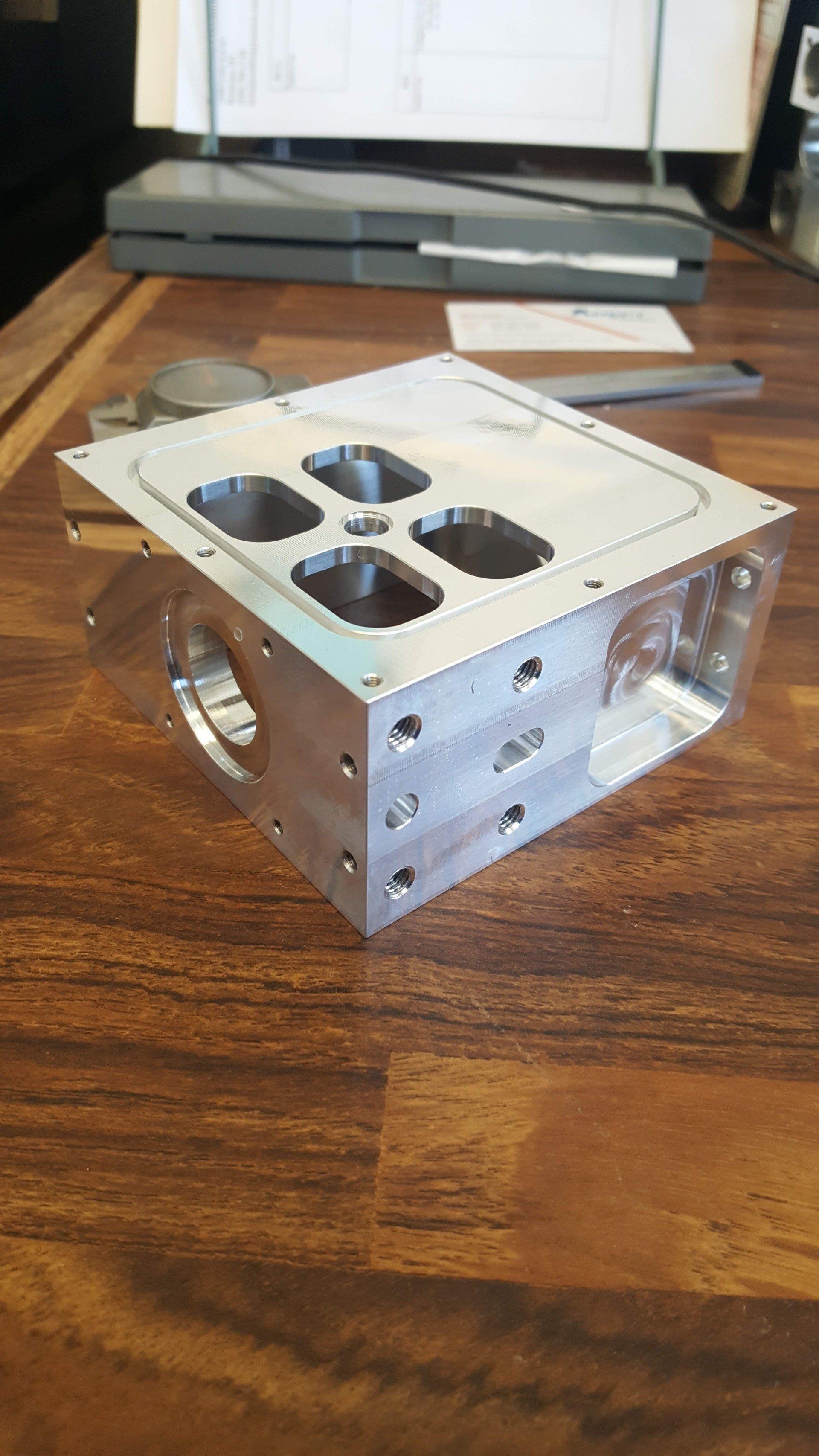 A piece of metal is sitting on top of a wooden table.