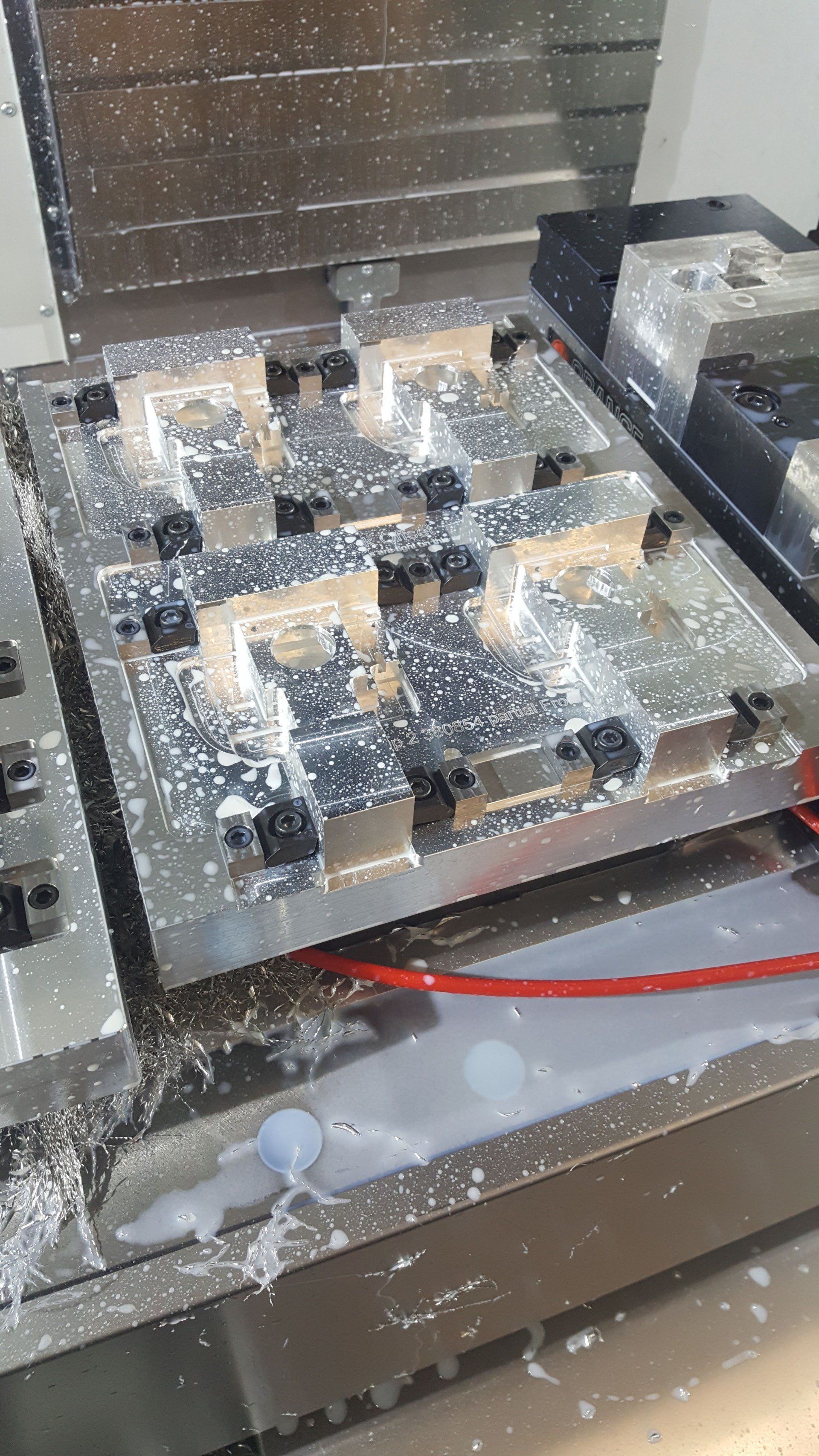 A machine is cutting a piece of metal on a table.