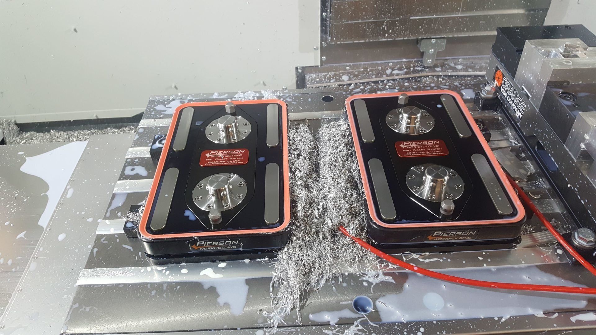 Two pieces of metal are sitting on top of a machine.