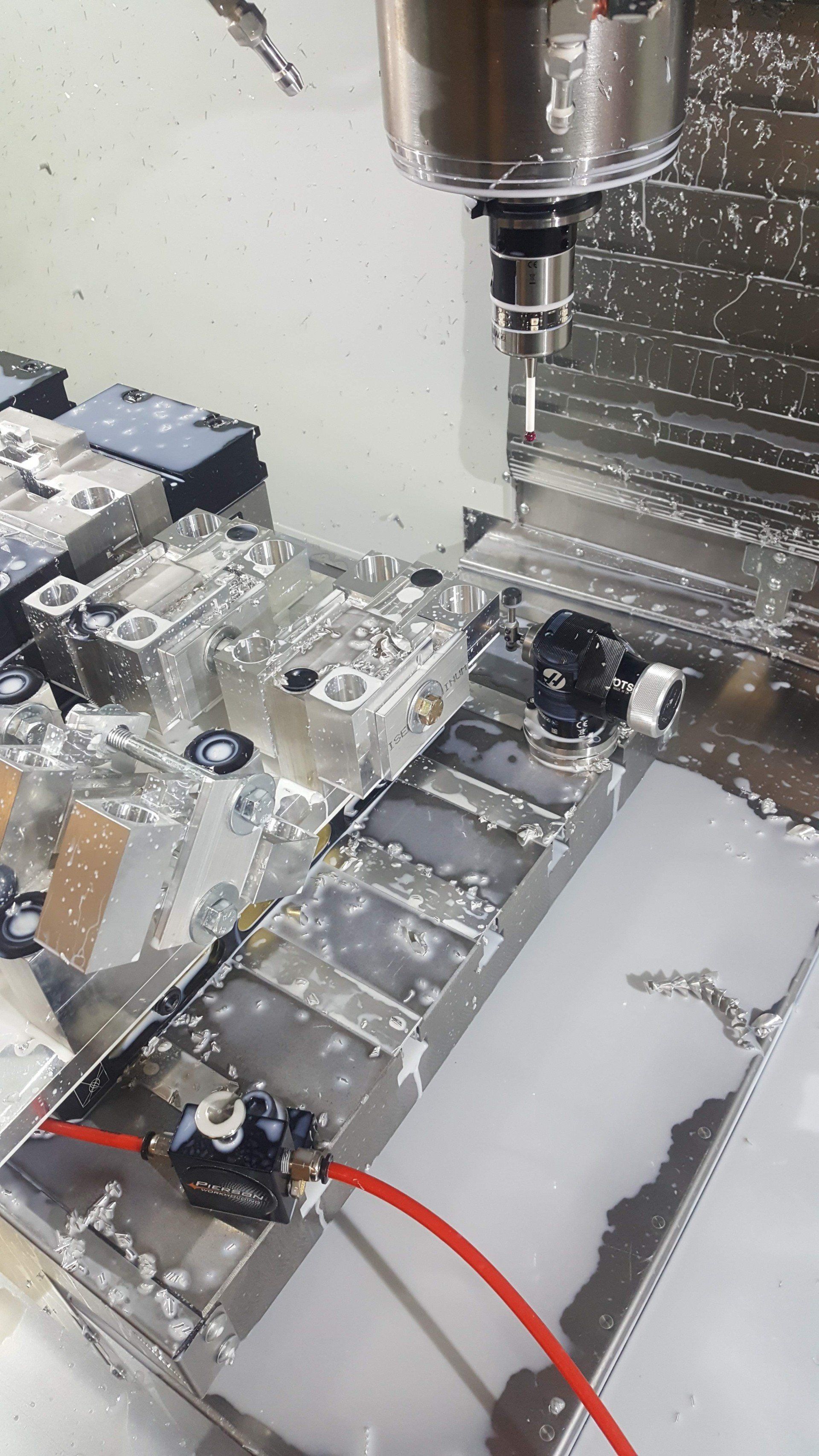 A machine is cutting a piece of metal on a table.