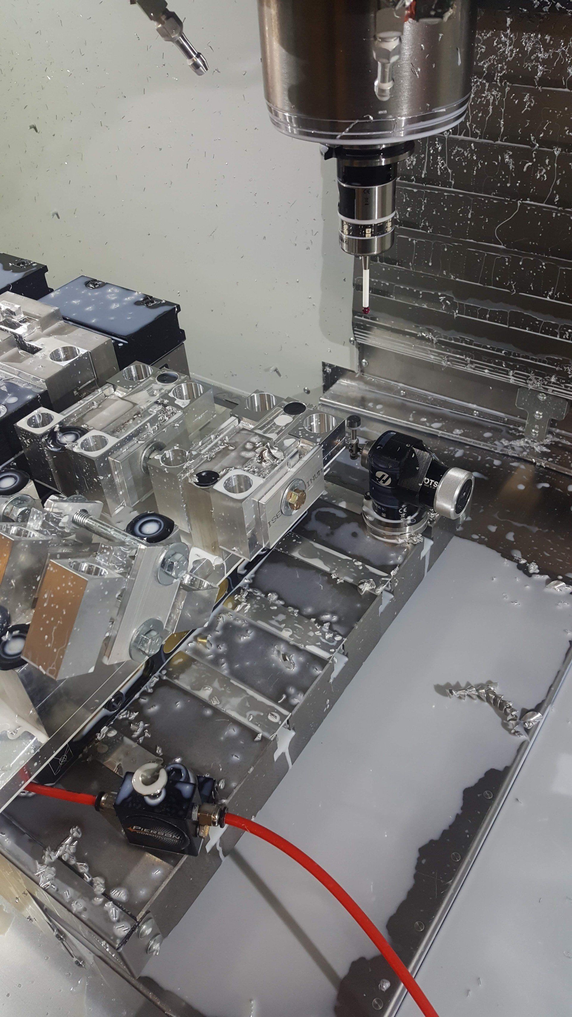 A machine is cutting a piece of metal on a table.