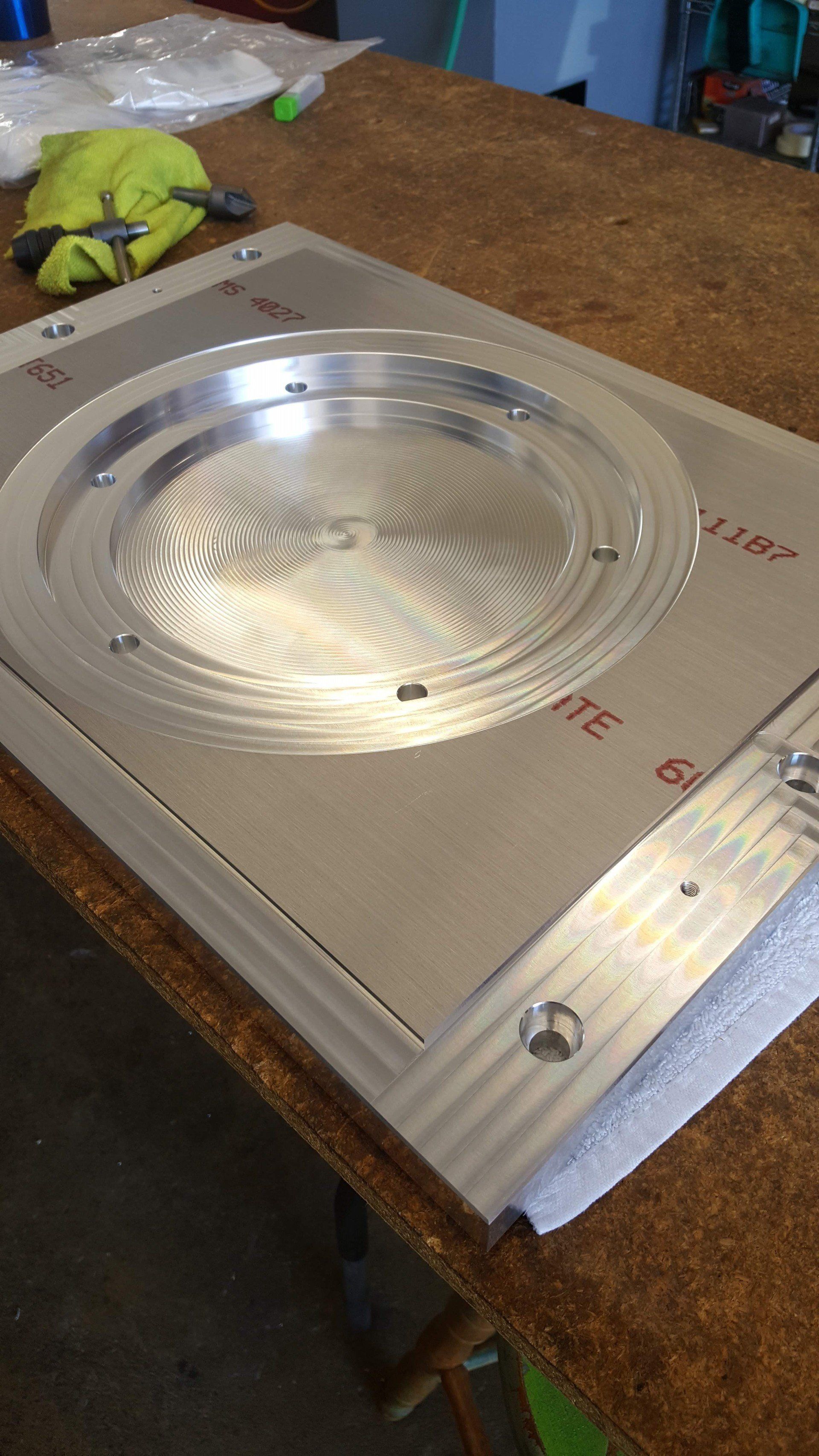 A metal plate is sitting on top of a wooden table.