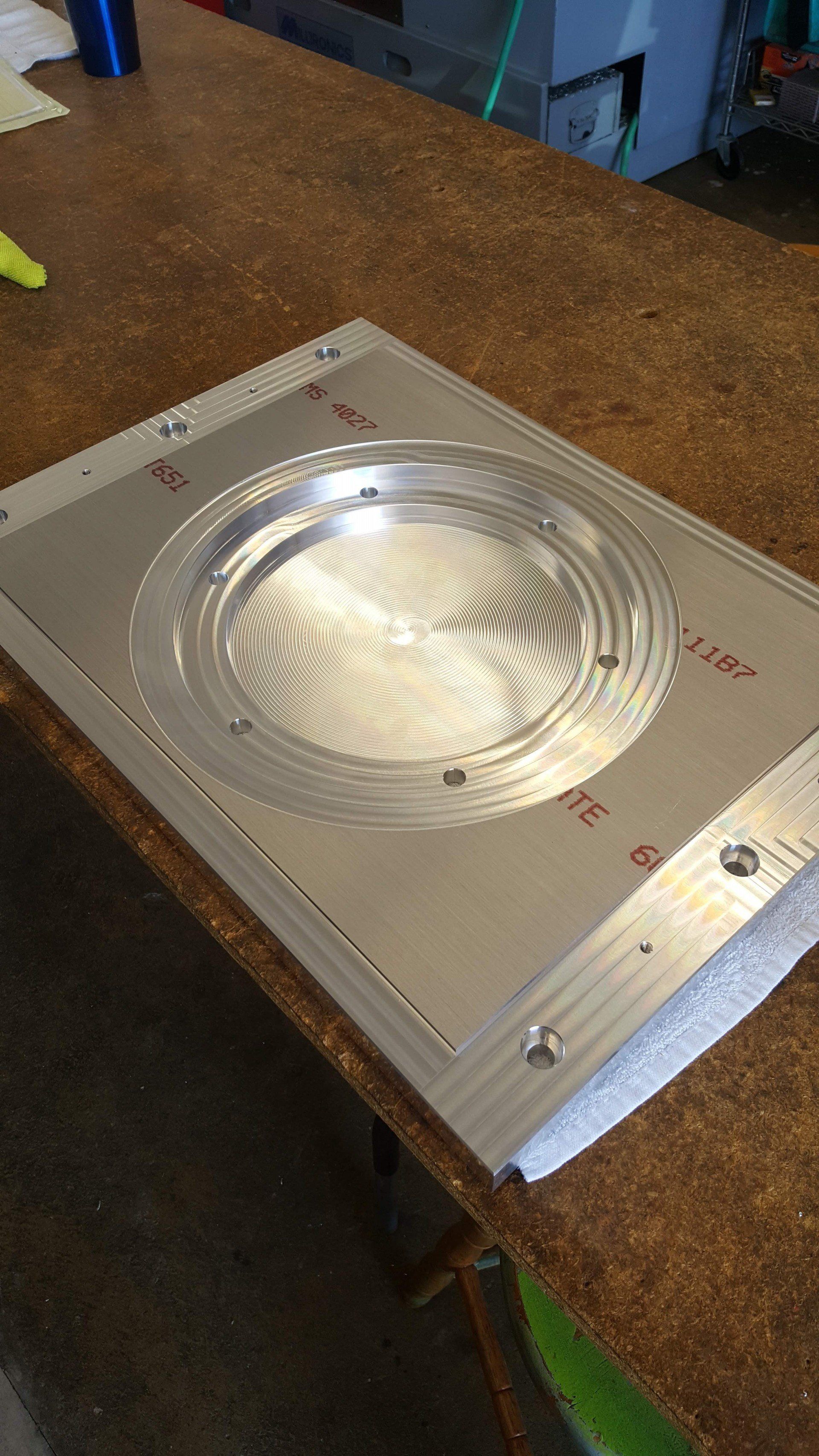 A metal plate is sitting on top of a wooden table.