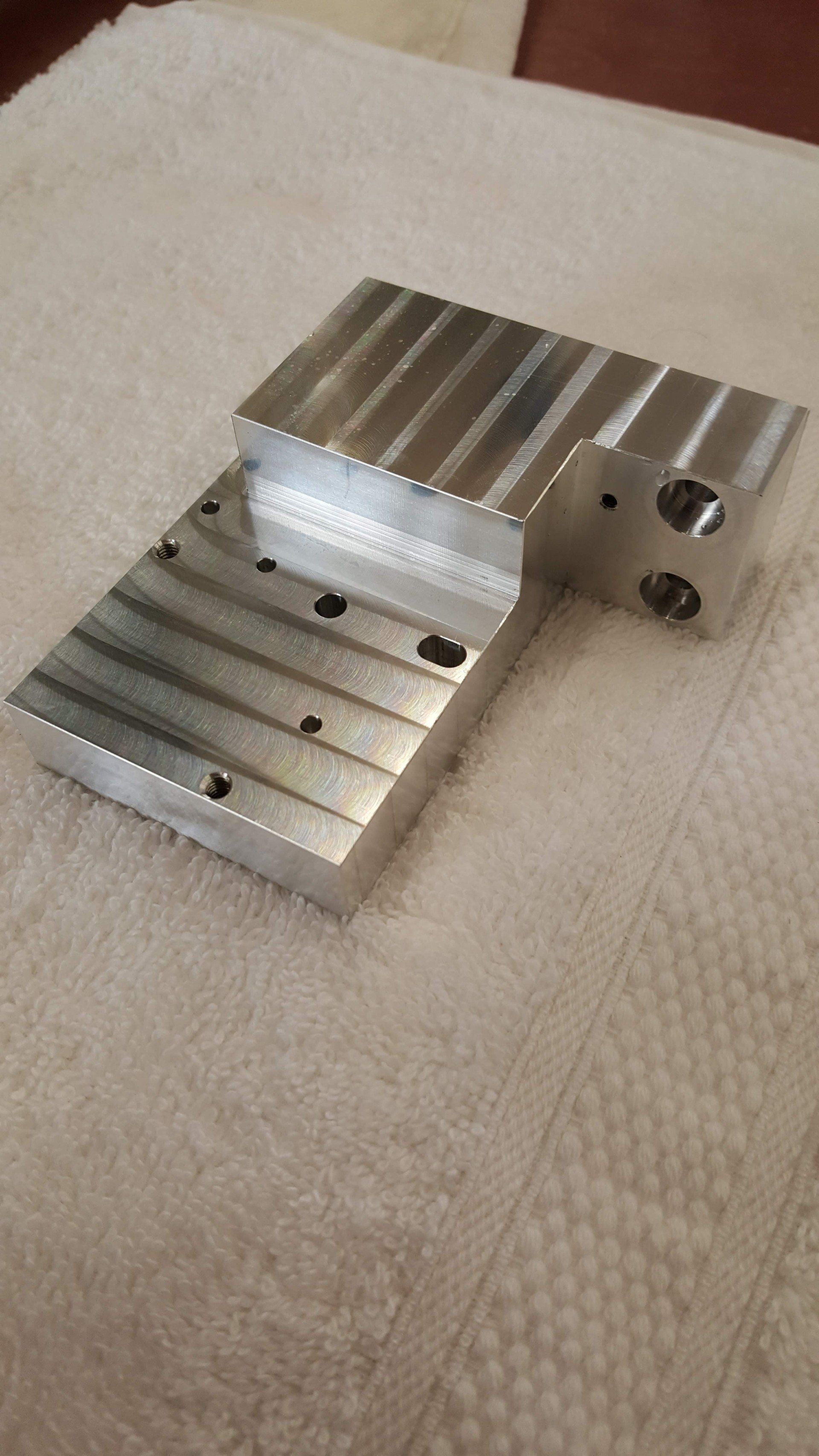 Two pieces of metal are sitting on top of a white towel.