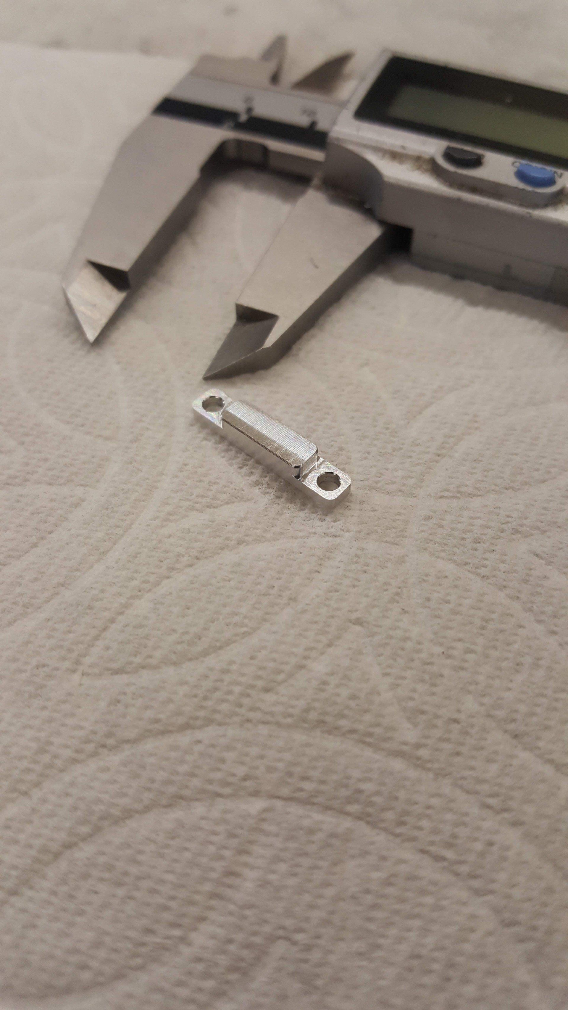 A digital caliper is sitting on top of a piece of paper towel.
