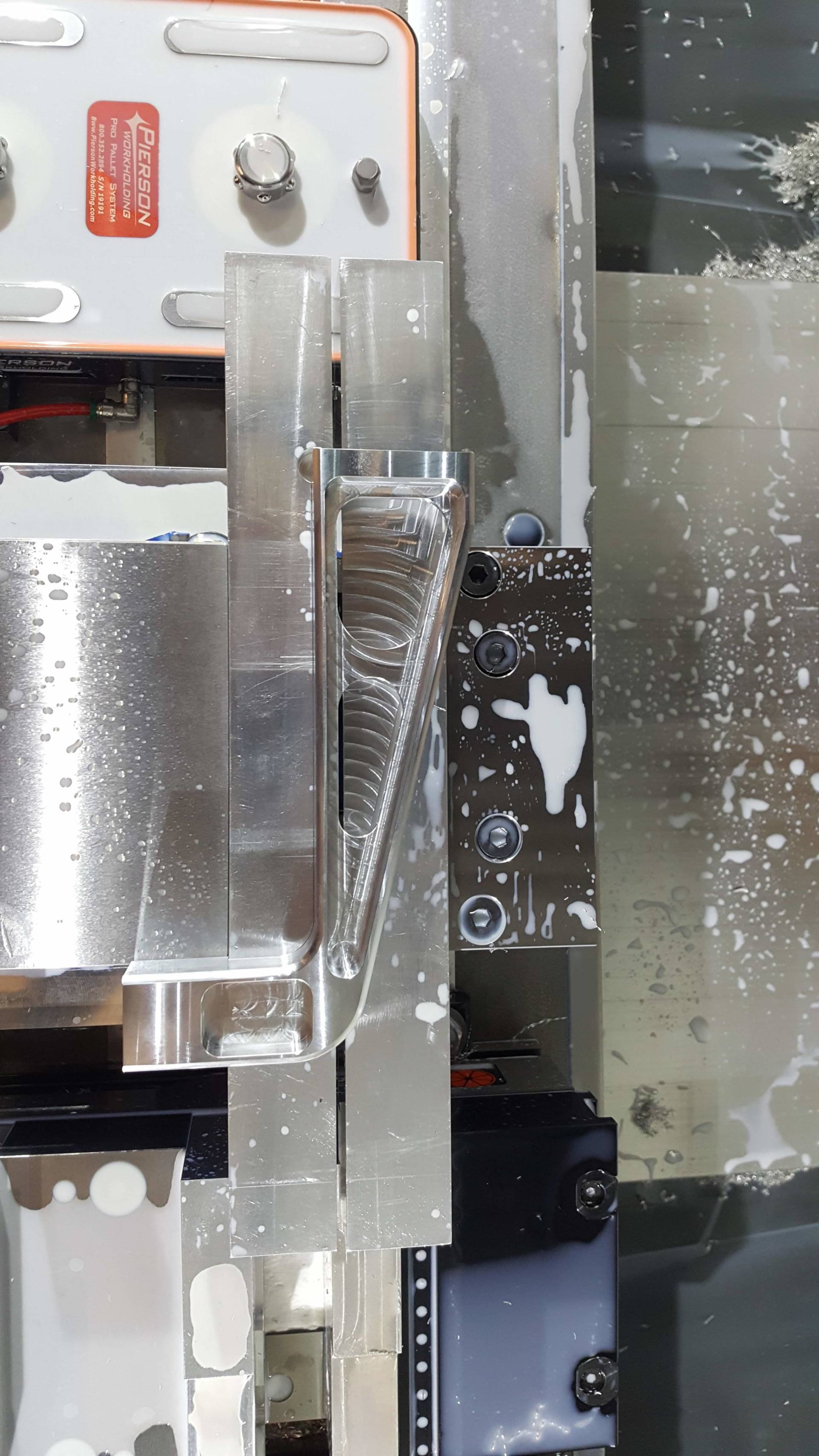 A machine is cutting a piece of metal in a factory.