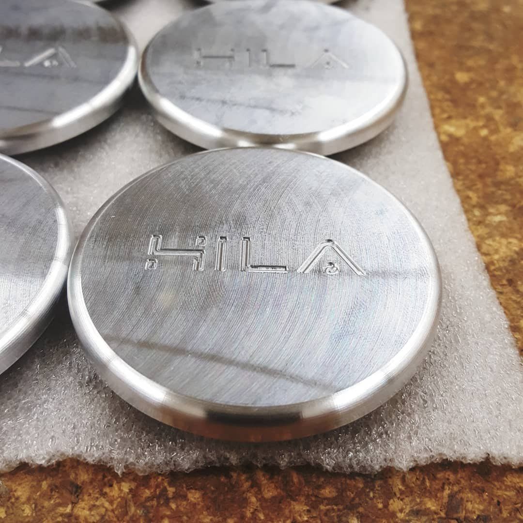 A group of silver coins with the word hila engraved on them