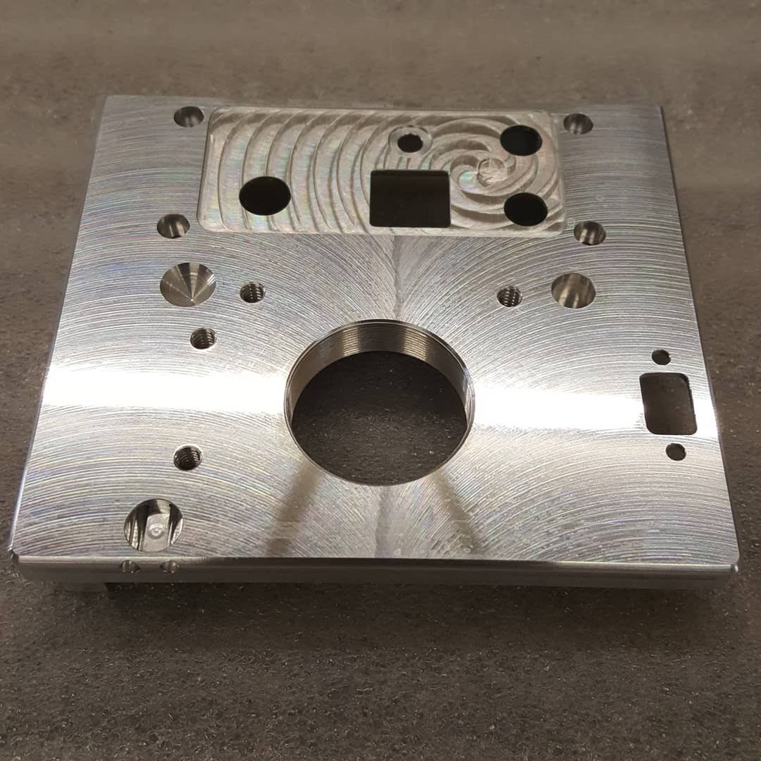 A metal plate with holes in it is sitting on a table.