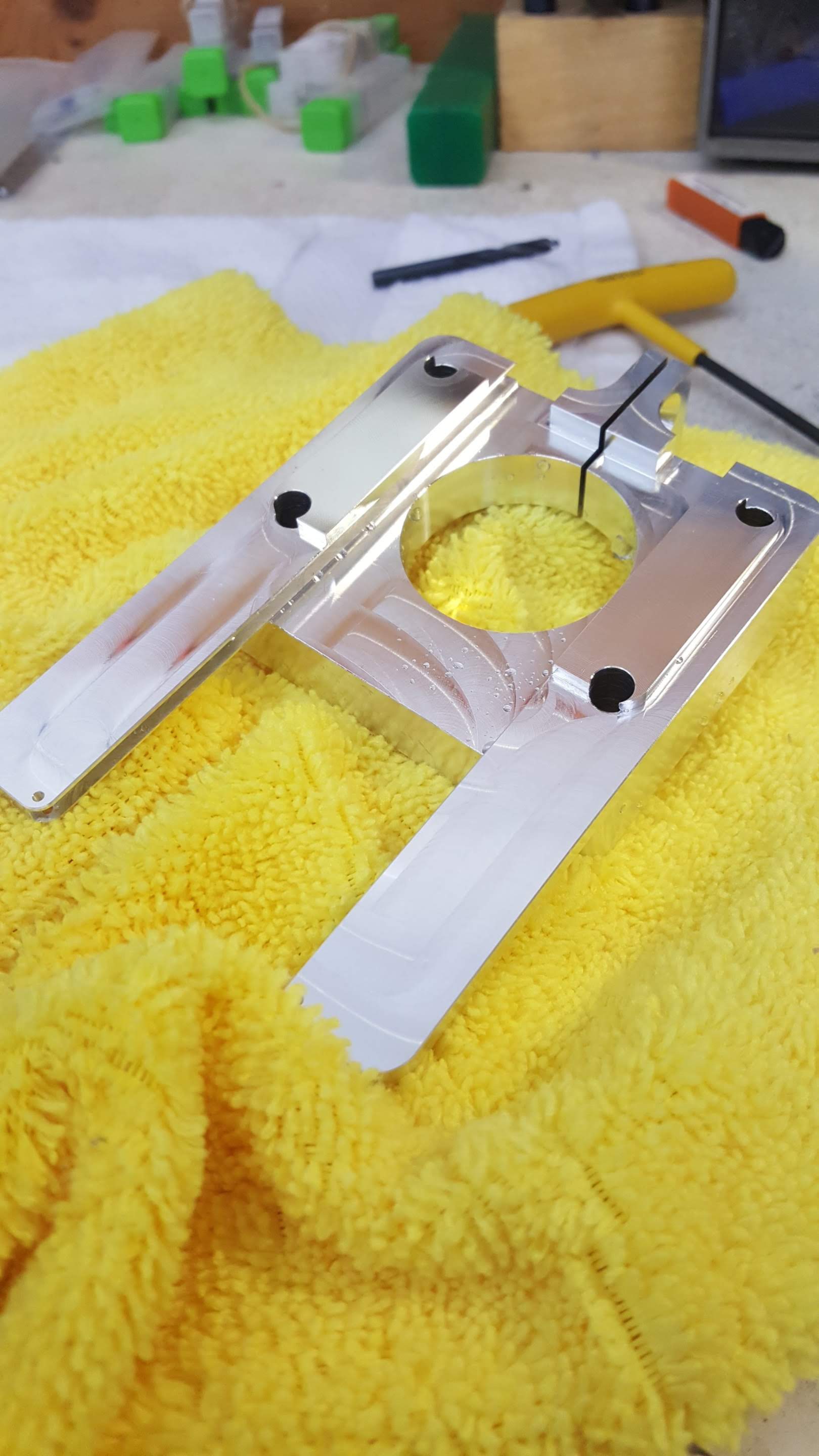 A piece of metal is sitting on top of a yellow towel.