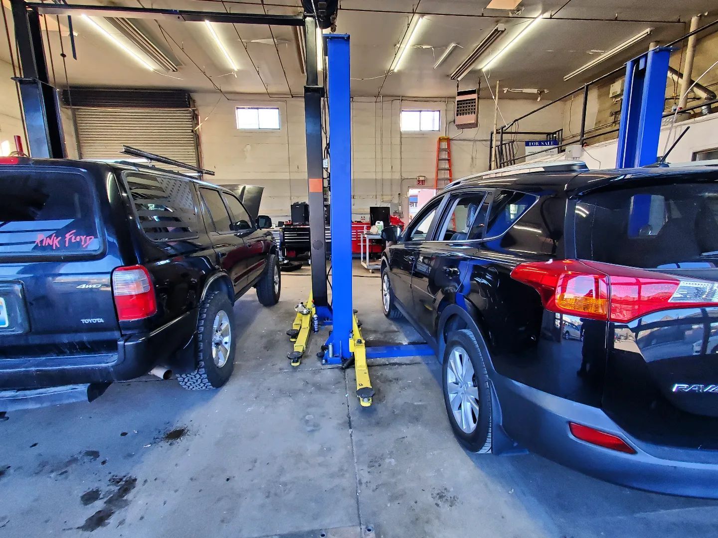 SUVs Positioned on Service Lifts Inside Auto Garage | Nonstop Auto Reno, NV