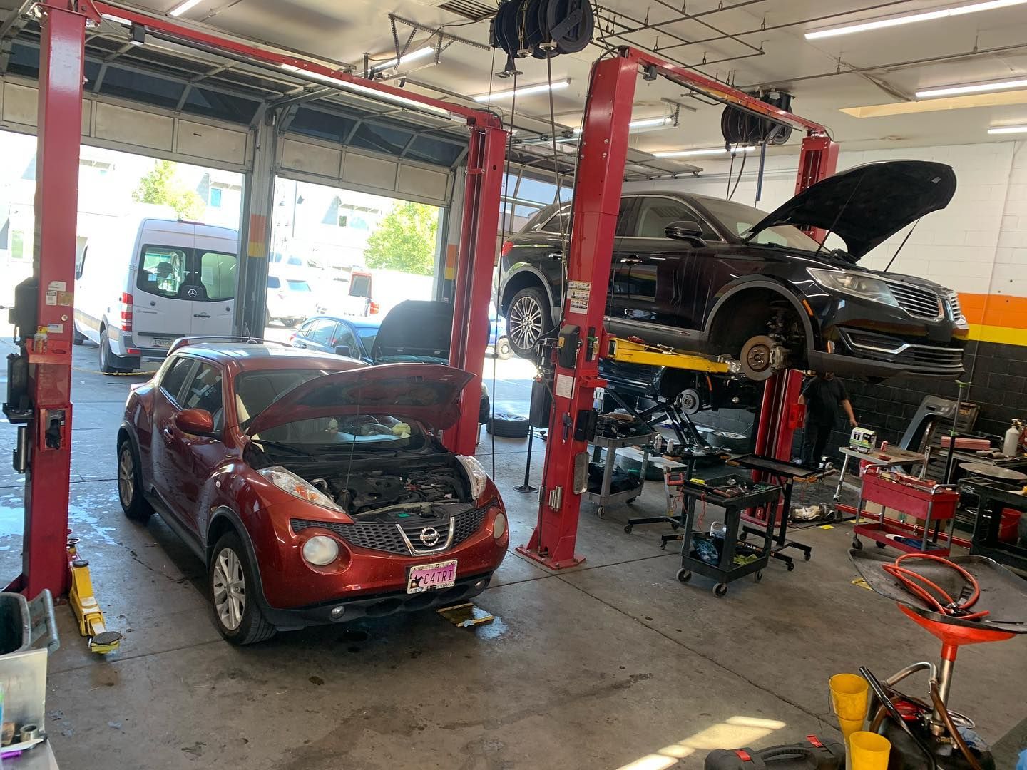 Multiple Cars on Hydraulic Lifts in Repair Facility | Nonstop Auto Reno, NV