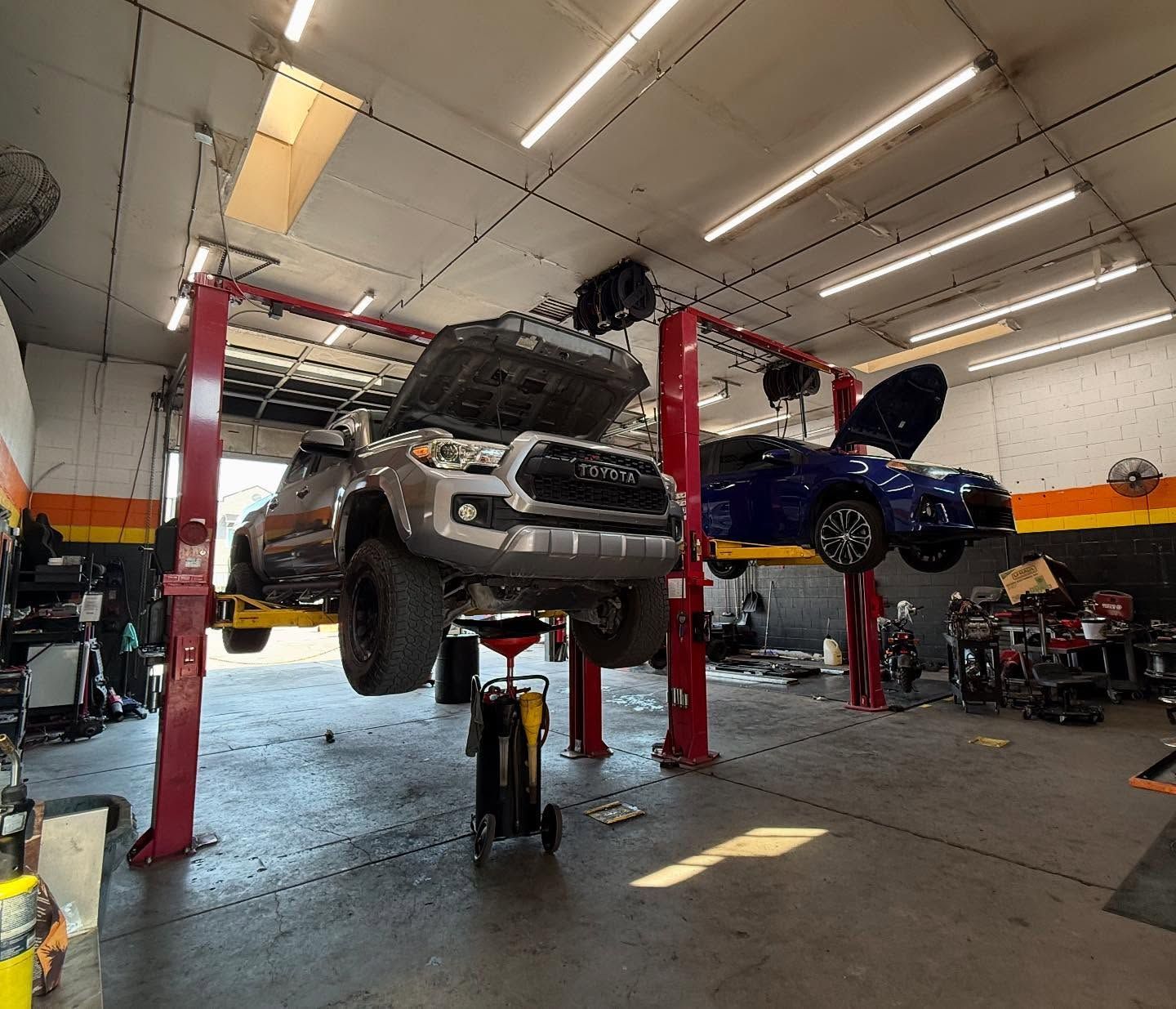 Vehicle Lifted for Inspection in Busy Auto Shop | Nonstop Auto Reno, NV