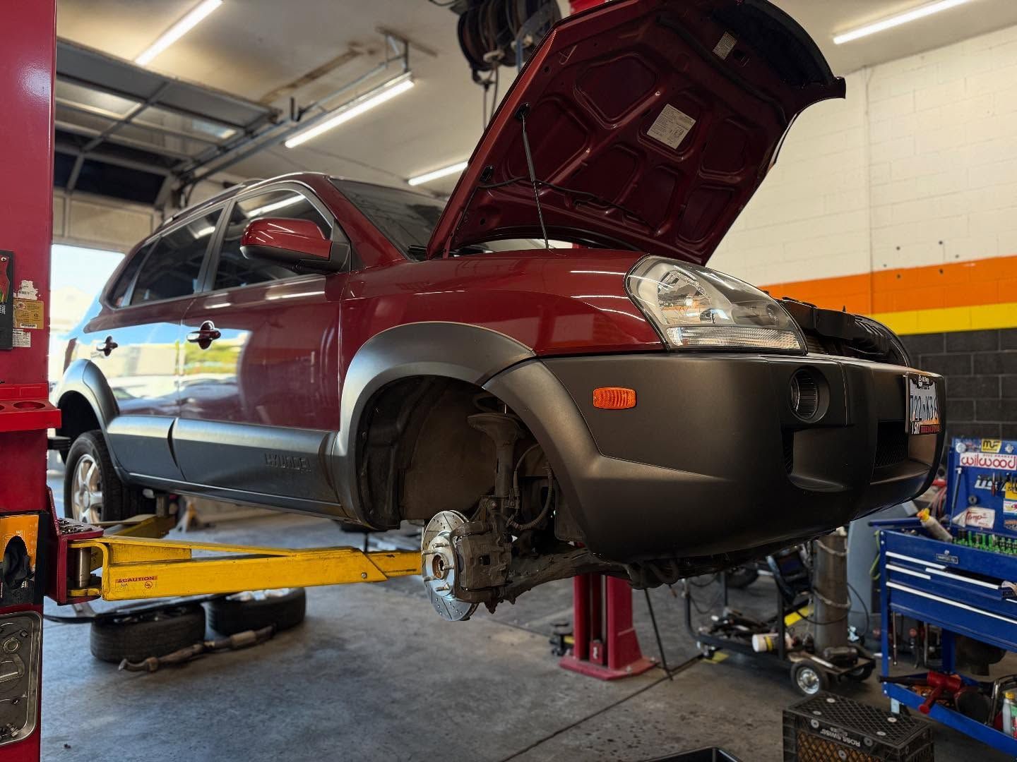 SUV Lifted for Brake and Wheel Service in Shop Bay | Nonstop Auto Reno, NV