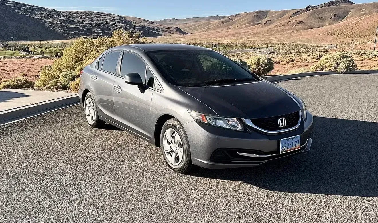 Gray Honda Civic parked on gravel with a desert landscape in the background | Nonstop Auto Reno, NV